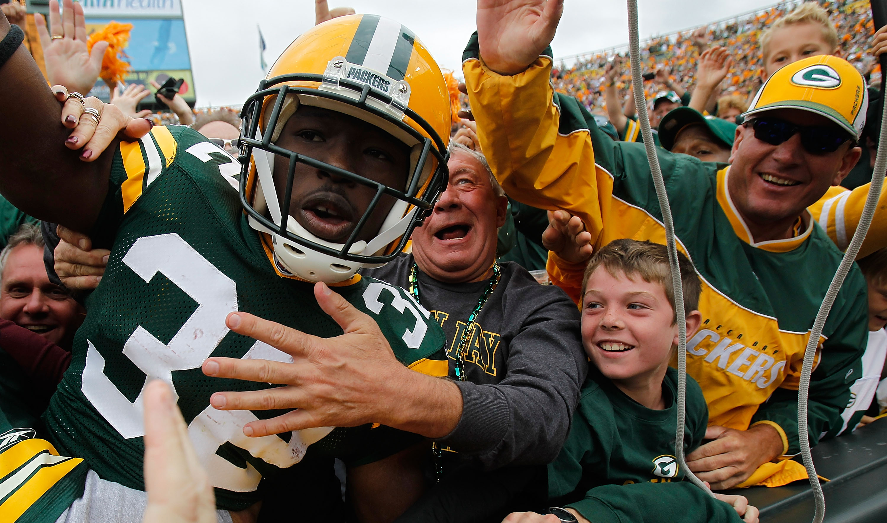 GREEN BAY, WI - SEPTEMBER 19: Brandon Jackson #32 of the Green Bay Packers celebrates a touchdown with a 'Lambeau Leap' into the stands against of the Buffalo Bills at Lambeau Field on September 19, 2010 in Green Bay, Wisconsin. (Photo by Jonathan Daniel/