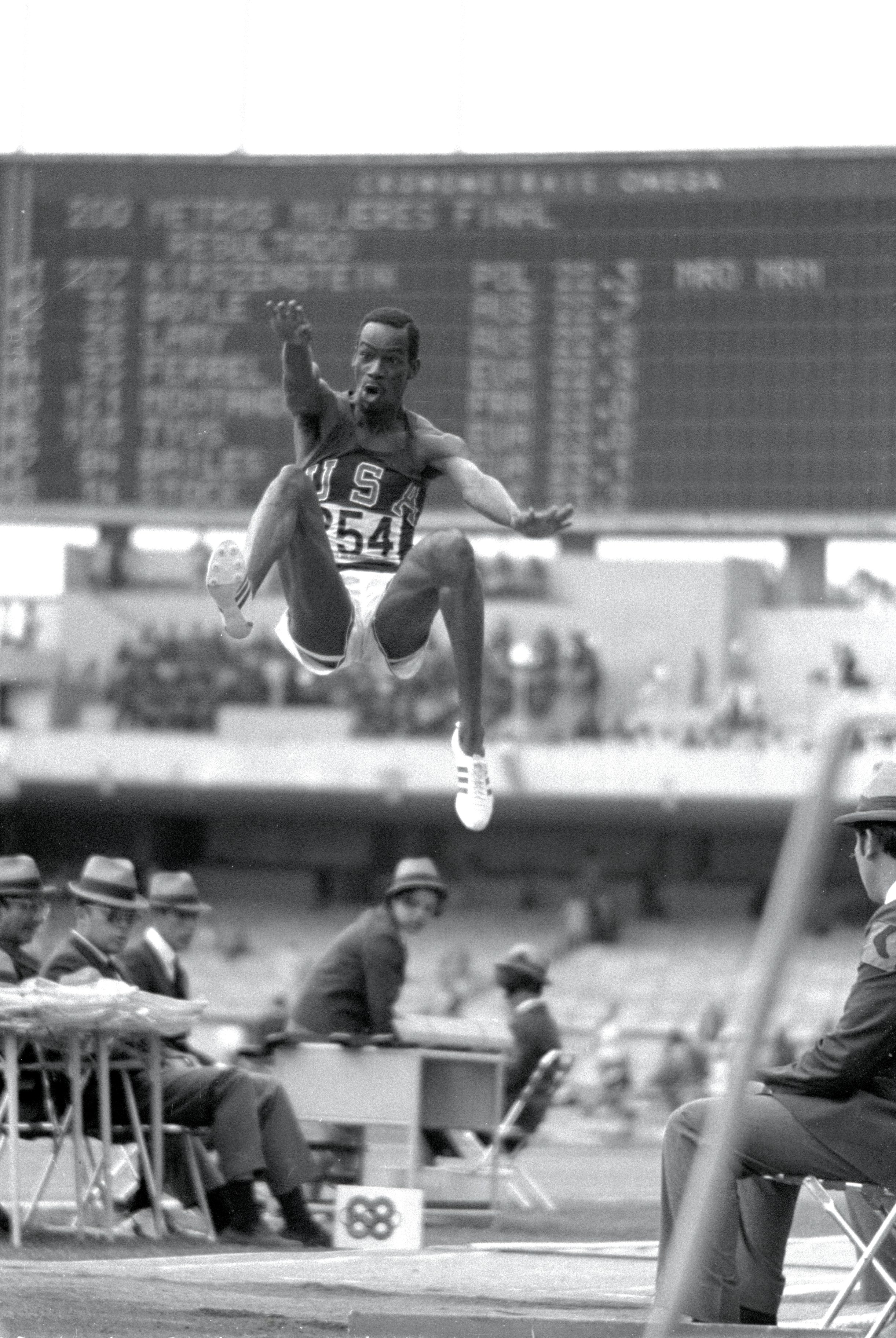 18 Oct 1968: Bob Beamon #254 of the USA breaking the Long Jump World Record during the 1968 Olympic Games in Mexico City, Mexico. Beamon long jumped 8.9 m (29 ft 2 1/2 in), winning the gold medal and setting a new world record. It is the first jump over 2