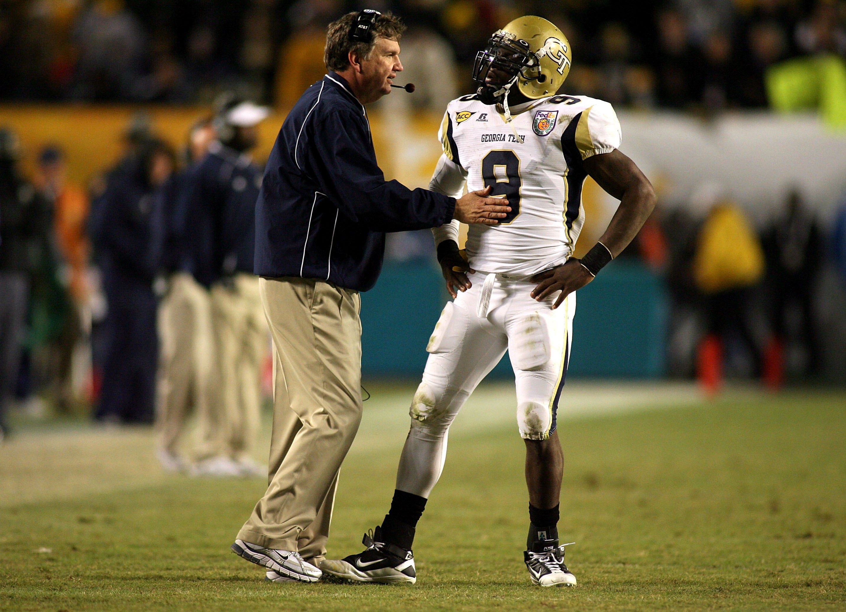 MIAMI GARDENS, FL - JANUARY 05: Head coach Paul Johnson of the Georgia Tech Yellow Jackets talks with quarterback Josh Nesbitt #9 against the Iowa Hawkeyes during the FedEx Orange Bowl at Land Shark Stadium on January 5, 2010 in Miami Gardens, Florida.