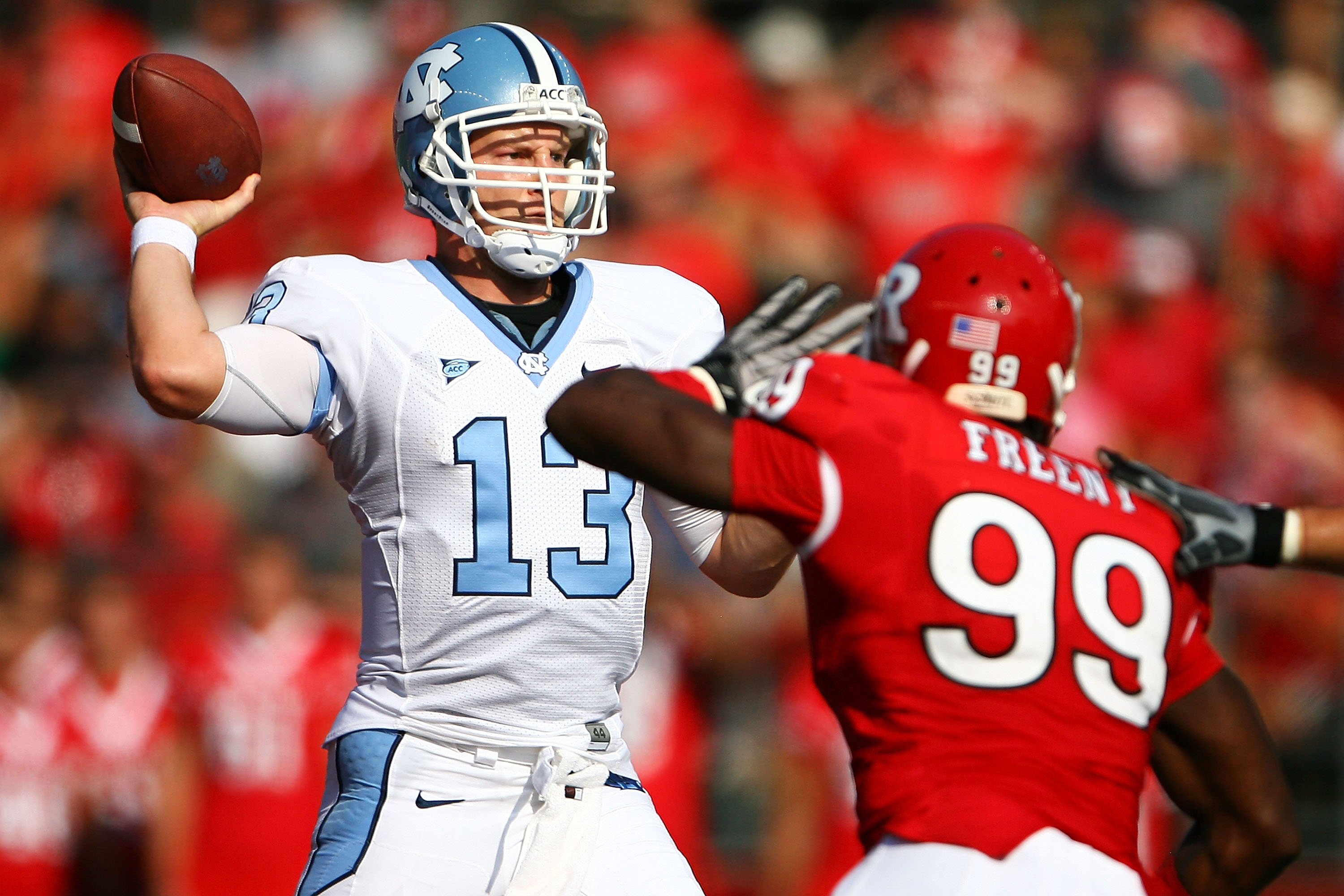 NEW BRUNSWICK, NJ - SEPTEMBER 25: Jonathan Freeny #99 of the Rutgers Scarlet Knights attempts to block a pass from T.J. Yates #13 of the North Carolina Tar Heels during a game at Rutgers Stadium on September 25, 2010 in New Brunswick, New Jersey. (Photo
