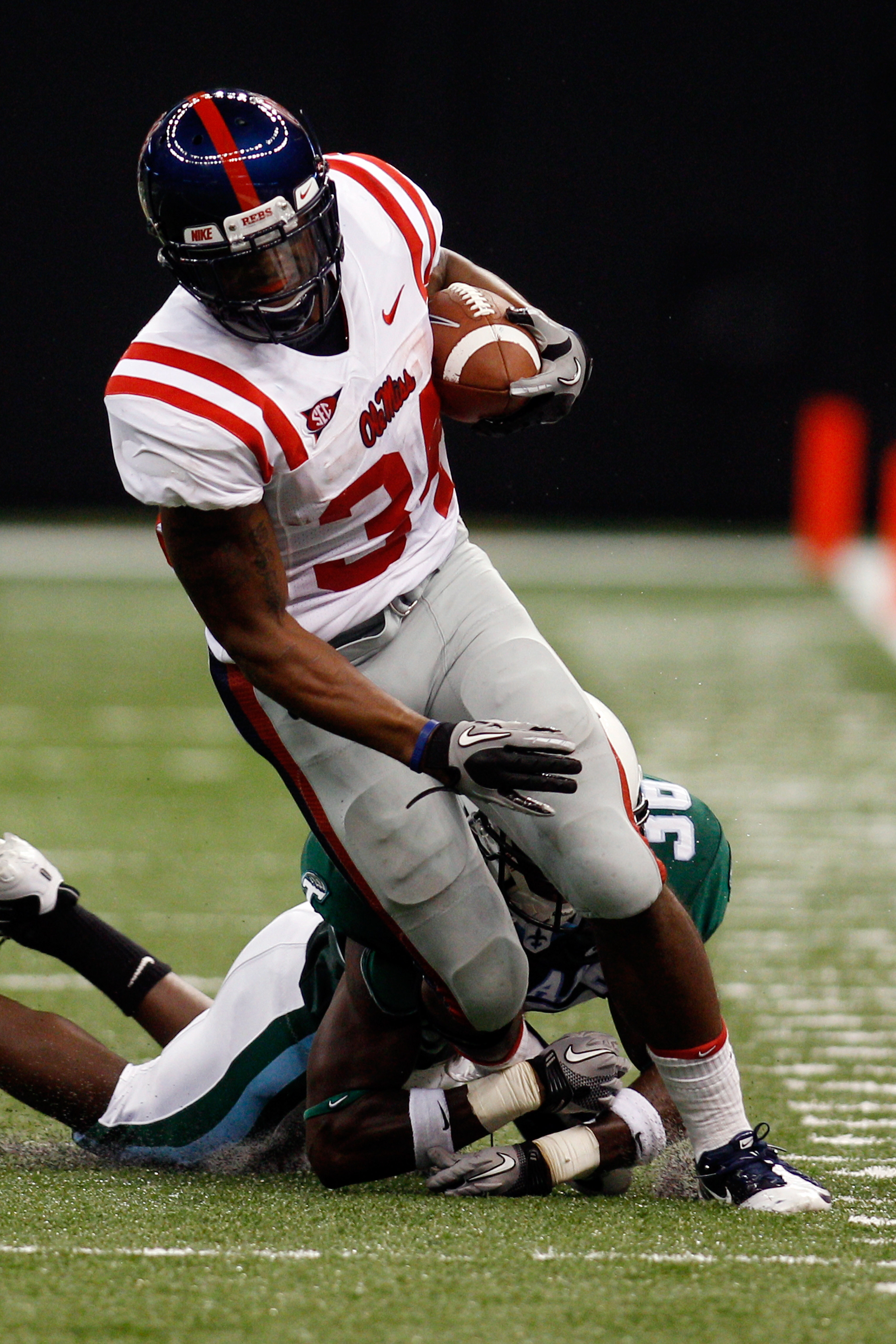 NEW ORLEANS - SEPTEMBER 11: Brandon Bolden #34 of the Ole Miss Rebels is chased by Dominique Robertson #36 of the Tulane Green Wave at the Louisiana Superdome on September 11, 2010 in New Orleans, Louisiana. (Photo by Chris Graythen/Getty Images)