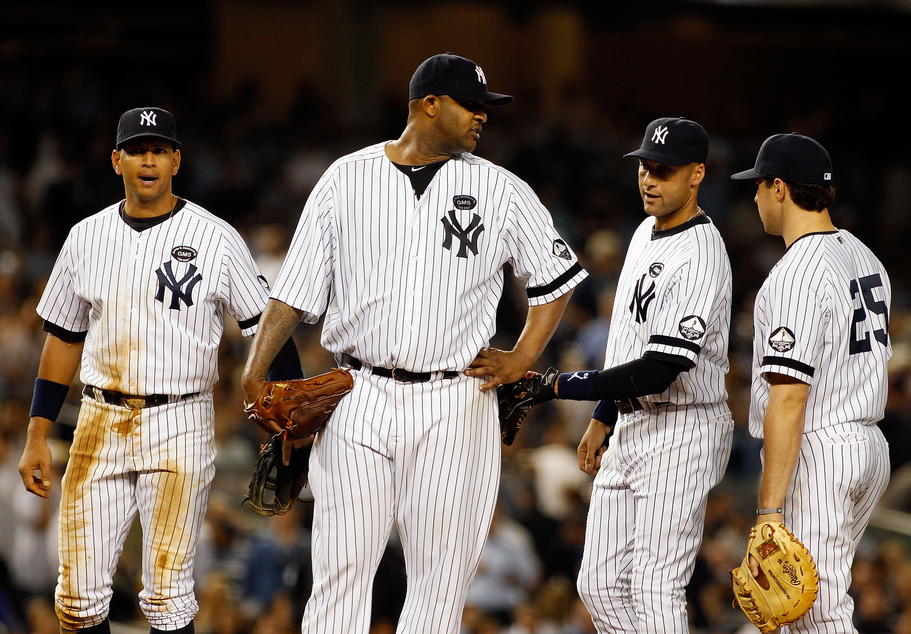 NEW YORK - SEPTEMBER 23:  CC Sabathia #52, Derek Jeter #2, Mark Teixeira #25 and Alex Rodriquez #13 of the New York Yankees looks on against the Tampa Bay Rays on September 23, 2010 at Yankee Stadium in the Bronx borough of New York City.  (Photo by Mike