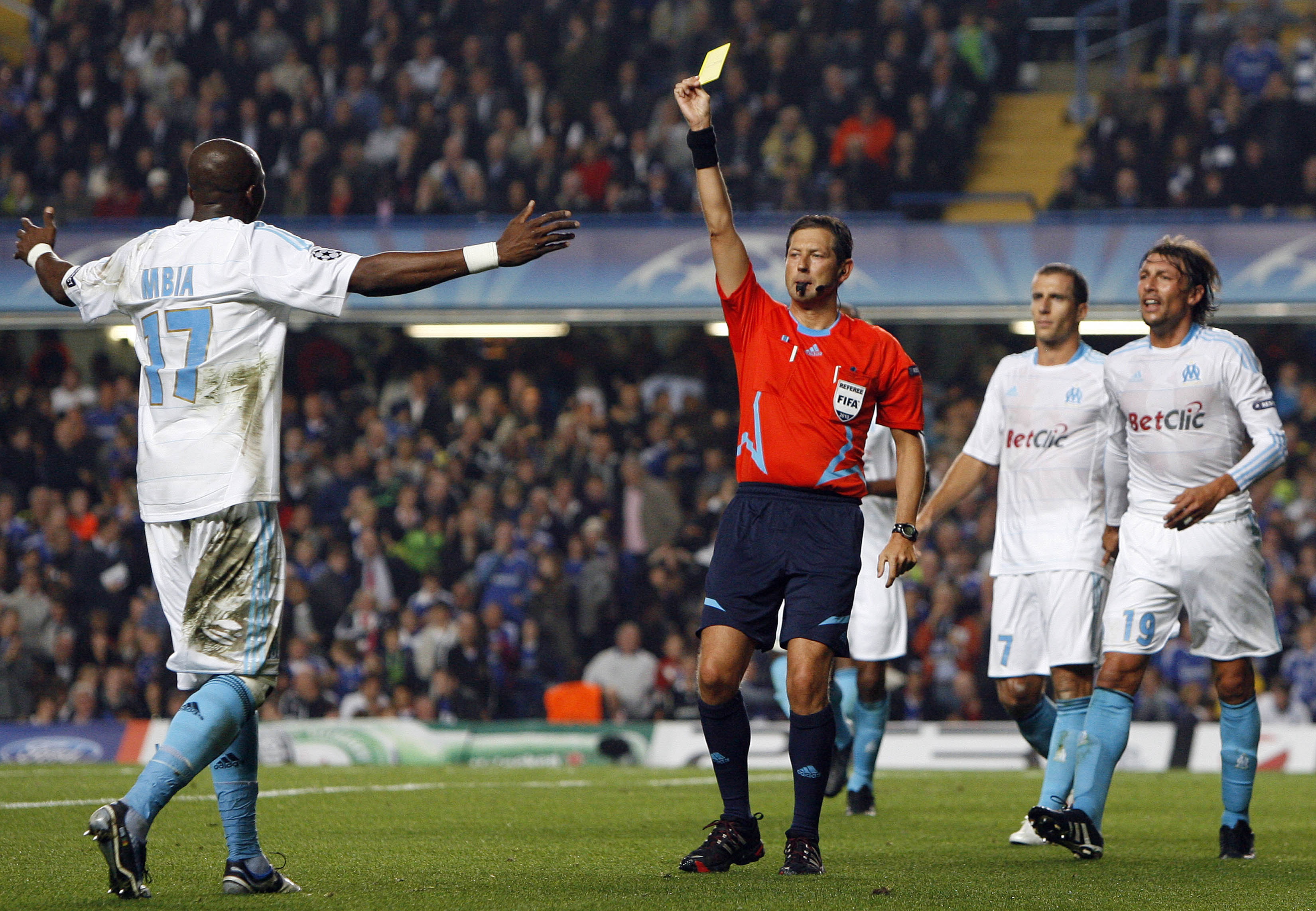 LONDON, ENGLAND - SEPTEMBER 28 :   Stephane Mbia of Marseille(L) shows his disappointment to Referee, Frank de Bleeckere after conceding a penalty for handball during the UEFA Champions League Group F match between Chelsea and Marseille at Stamford Bridge