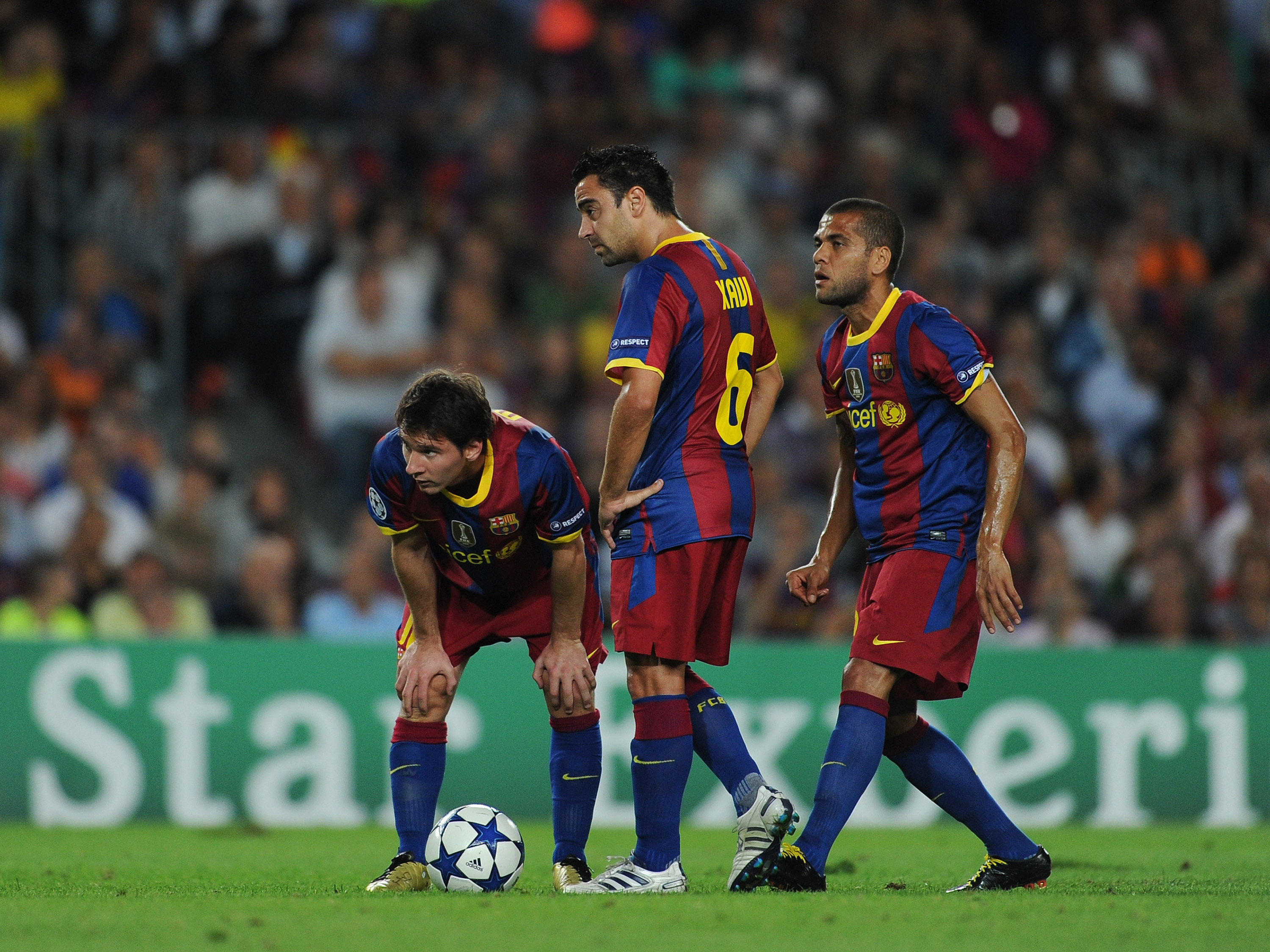BARCELONA, SPAIN - SEPTEMBER 14:  Lionel Messi, Xavi Hernandez and Daniel Alves of Barcelona line up a free kick during the UEFA Champions League group D match between Barcelona and Panathinaikos on September 14, 2010 in Barcelona, Spain. Barcelona won th
