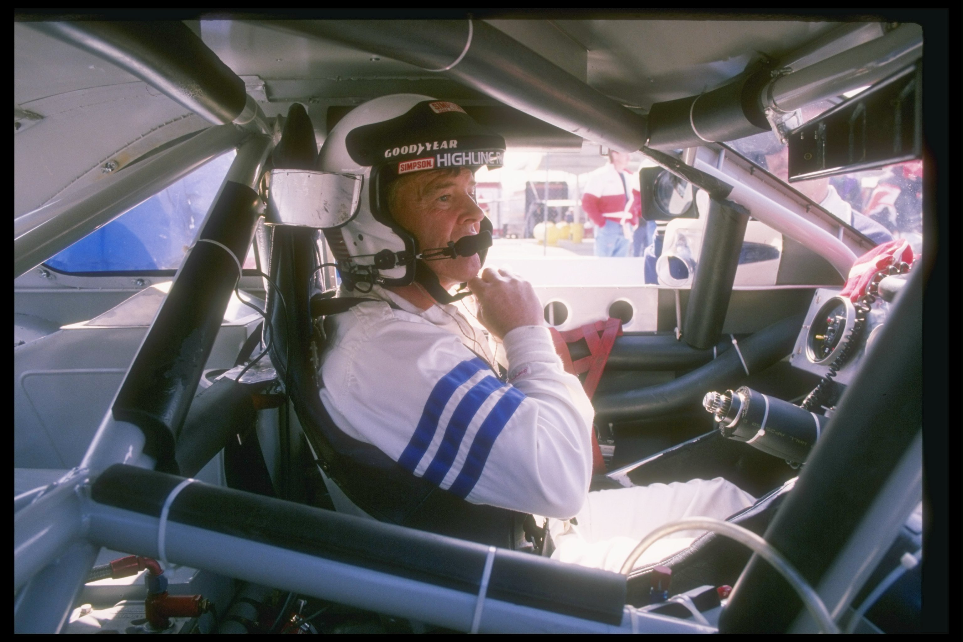 Dick Trickle sits in his car before the start of a NASCAR race.