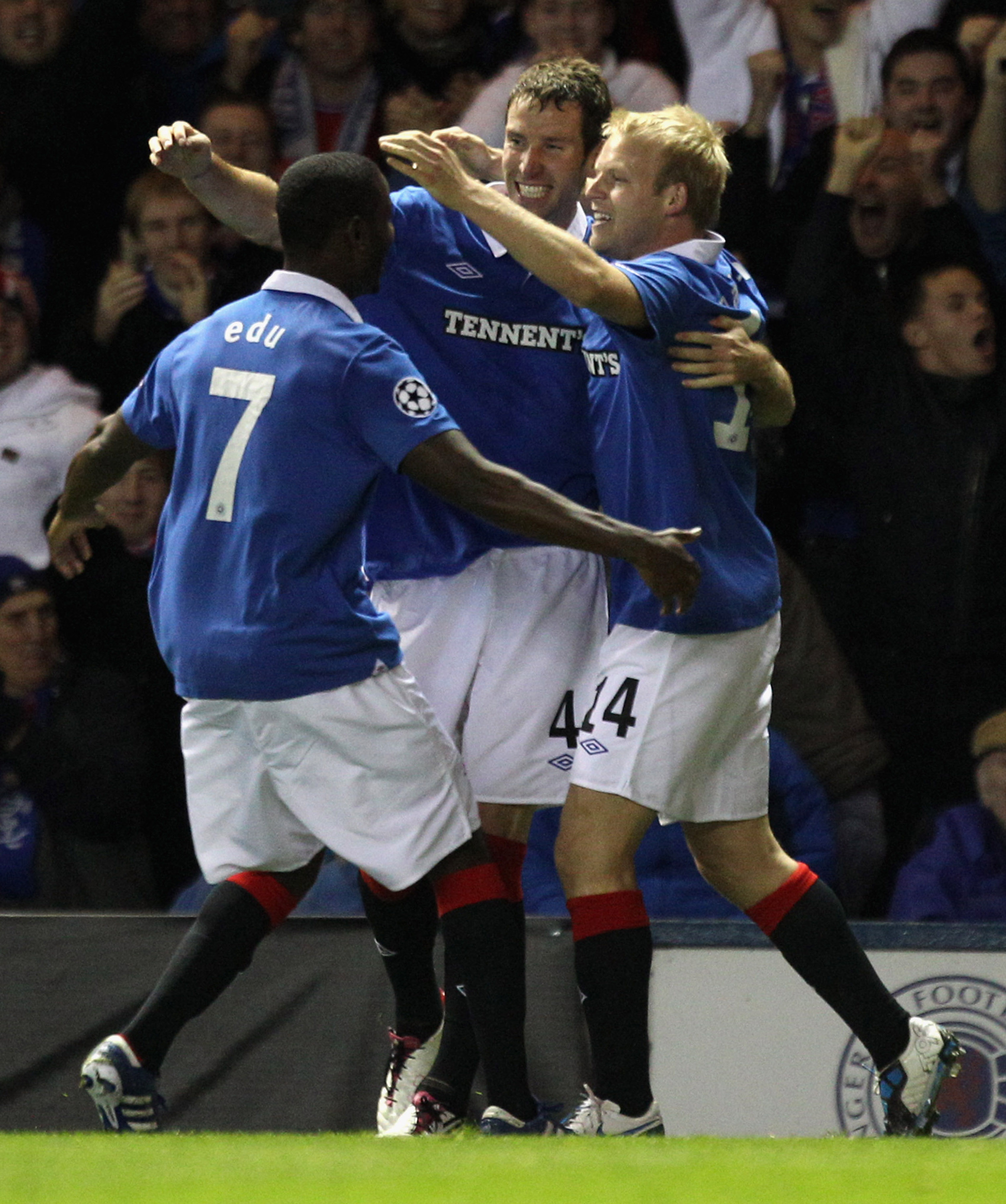 GLASGOW, SCOTLAND - SEPTEMBER 29:  Steven Naismith of Rangers celebrates with Daryl Broadfoot and Edu during the UEFA Champions League Group C match between Rangers and Buraspor Kulubu at Ibrox Stadium on September 29, 2010 in Glasgow, Scotland..  (Photo