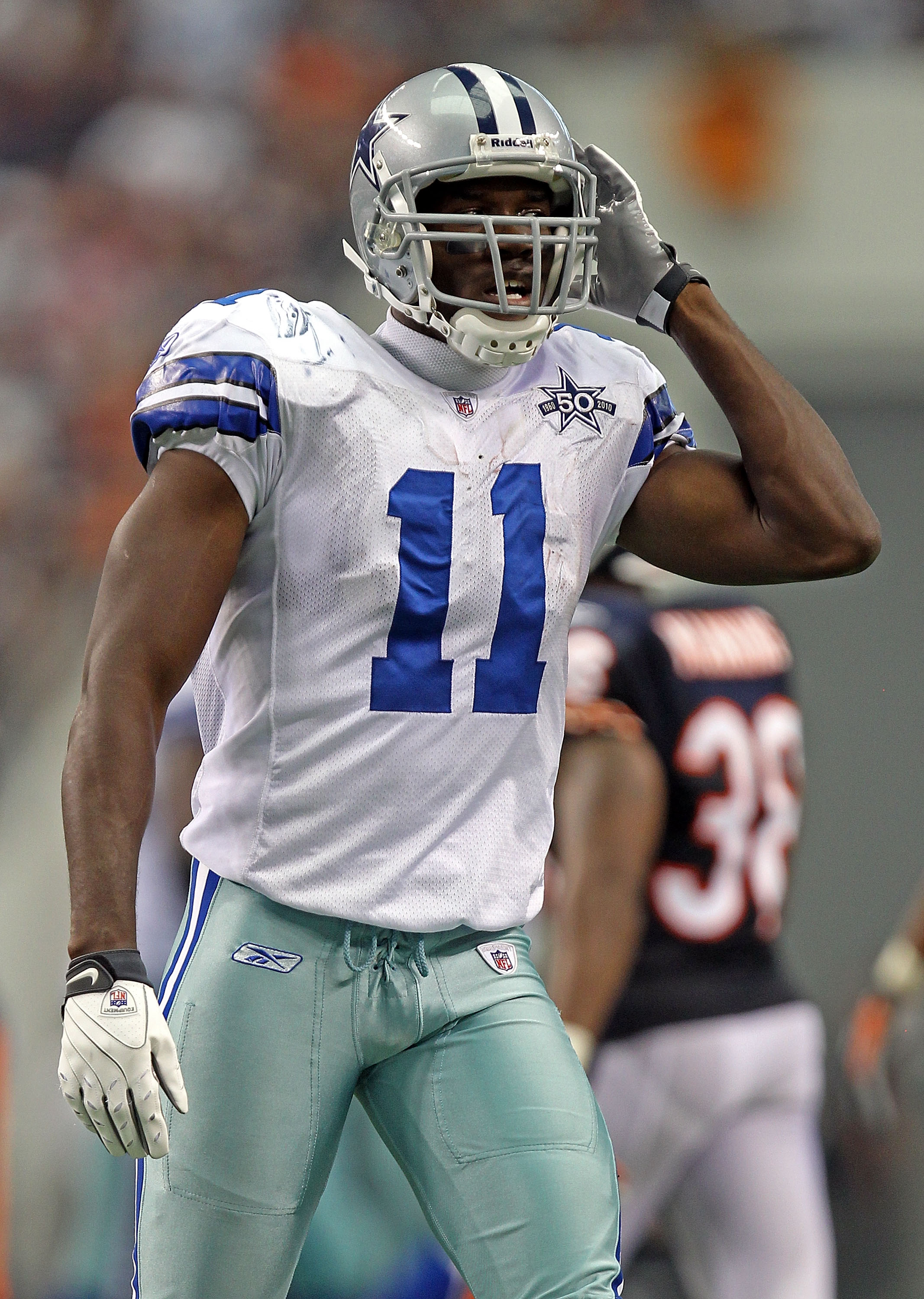 Dallas Cowboys wide receiver Roy E. Williams (11) signals first