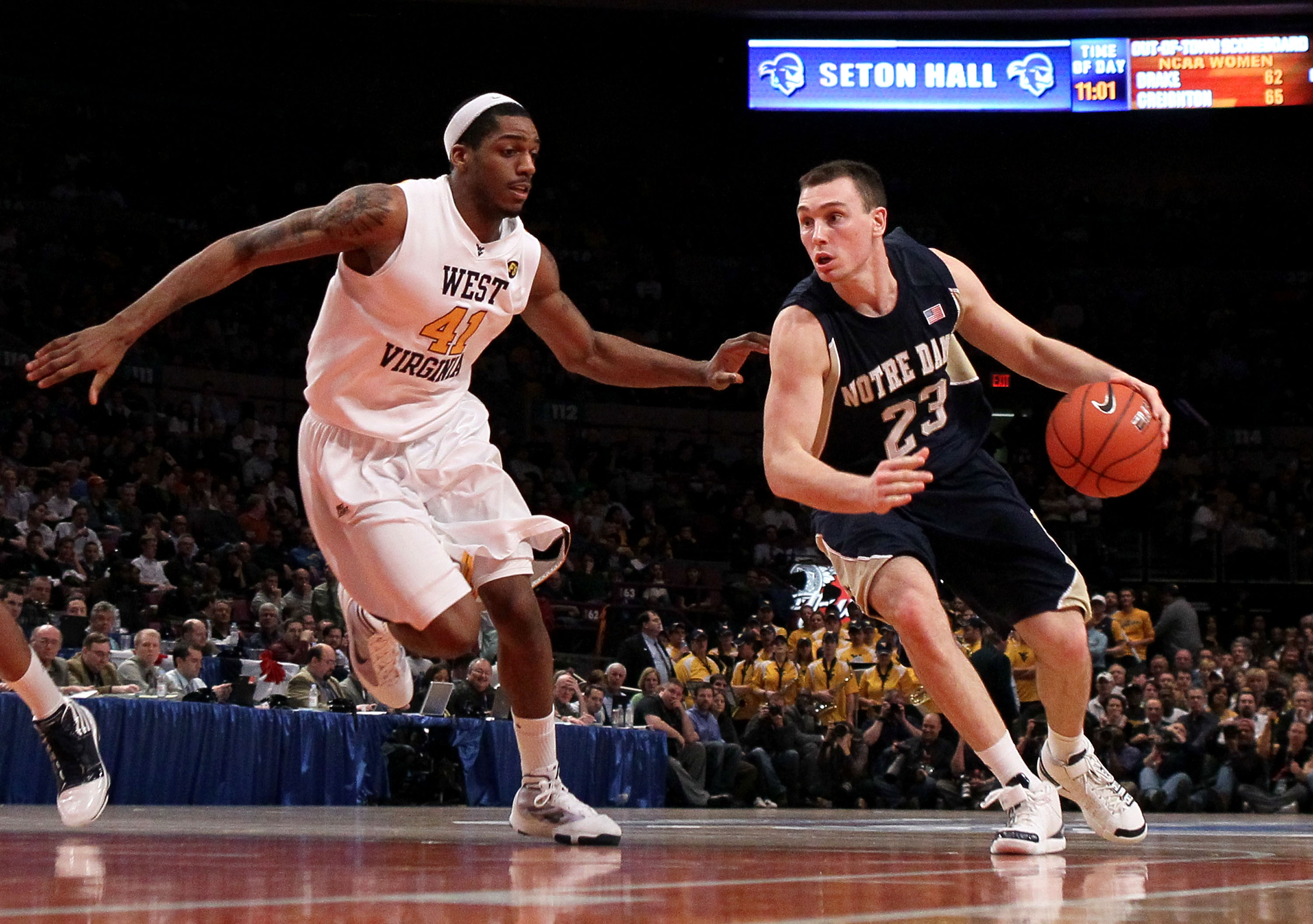 NEW YORK - MARCH 12: Ben Hansbrough #23 of the Notre Dame Fighting Irish handles the ball against John Flowers #41 of the West Virginia Mountaineers during the semifinal of the 2010 Big East Tournament at Madison Square Garden on March 12, 2010 in New Yor