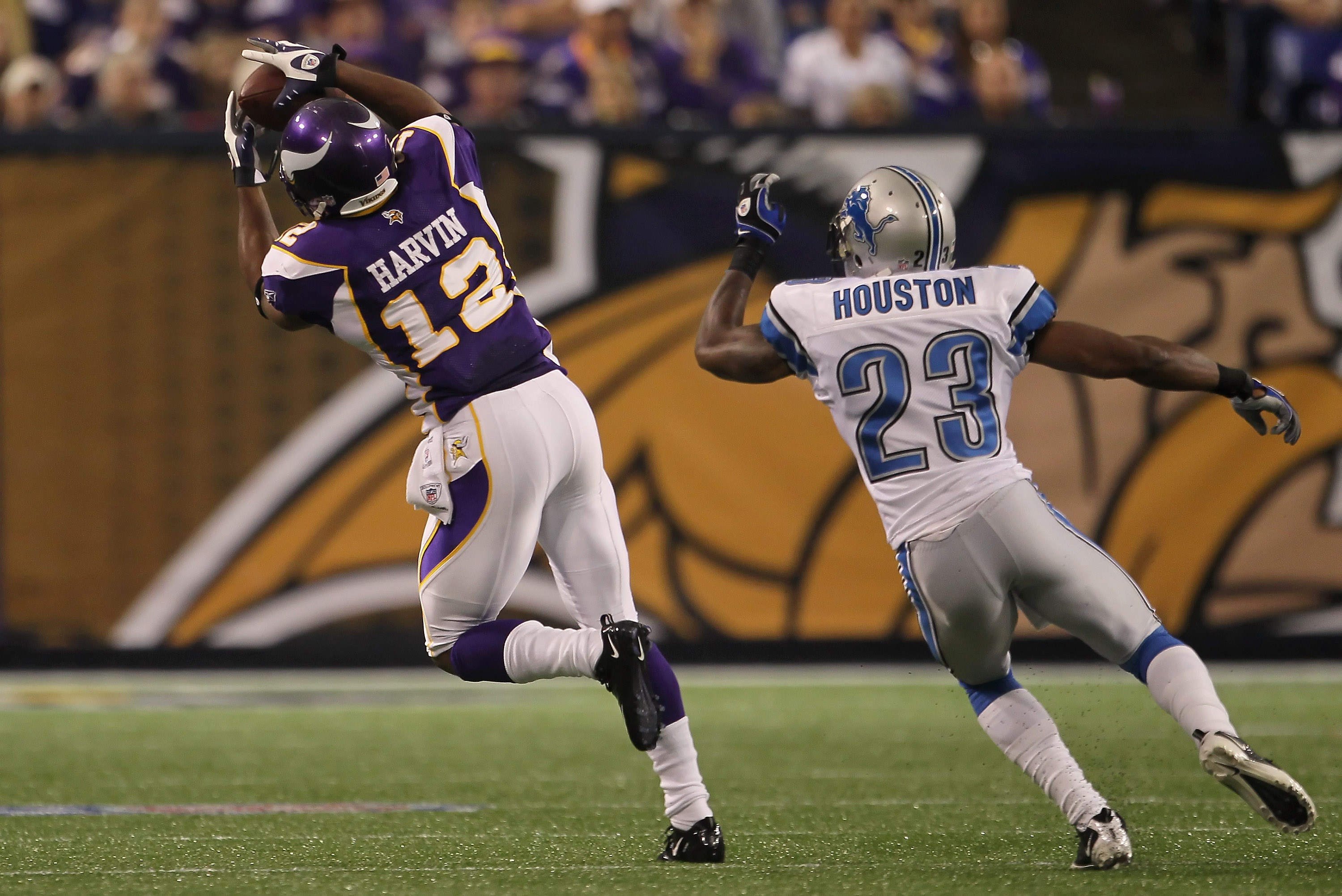 MINNEAPOLIS - SEPTEMBER 26:  Wide receiver Percy Harvin #12 of the Minnesota Vikings makes a catch for a reception in front of Chris Houston #23 of the Detroit Lions during the first half at Hubert H. Humphrey Metrodome on September 26, 2010 in Minneapoli