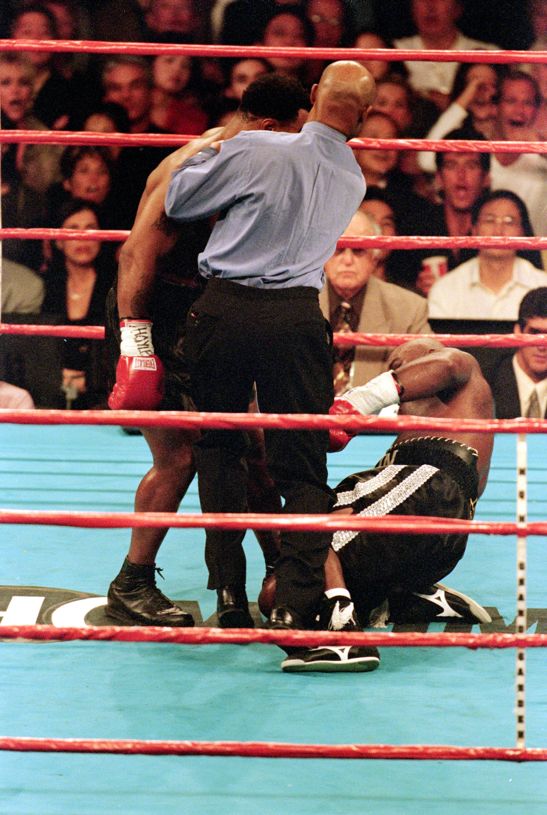 23 Oct 1999: Mike Tyson knocks down Orlin Norris after the bell during the fight at the MGM Grand Hotel in Las Vegas, Nevada. The fight ended in a no contest.