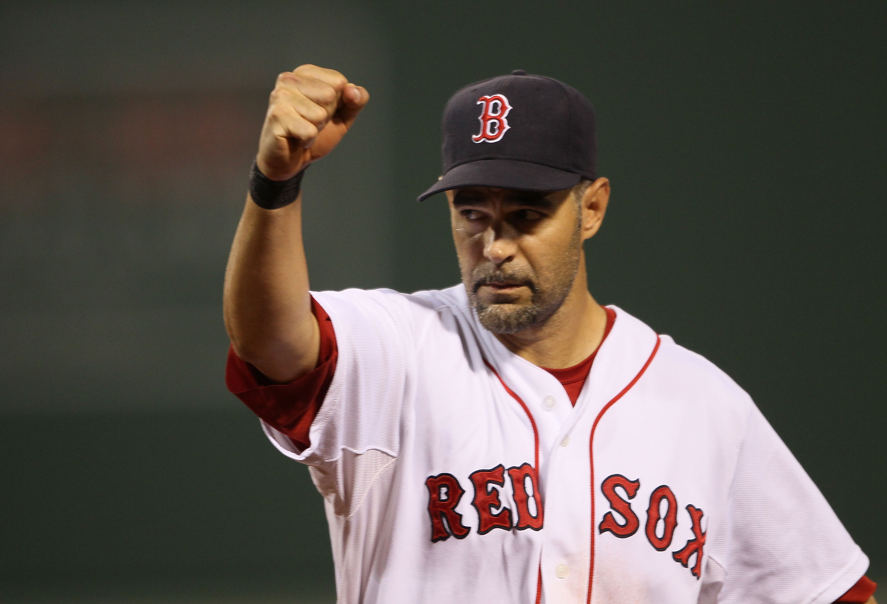 BOSTON - AUGUST 19:  Mike Lowell #25 of the Boston Red Sox celebrates as teammate J.D. Drew makes the catch for the final out of the third inning against the Los Angeles Angels of Anaheim on August 19, 2010 at Fenway Park in Boston, Massachusetts.  (Photo