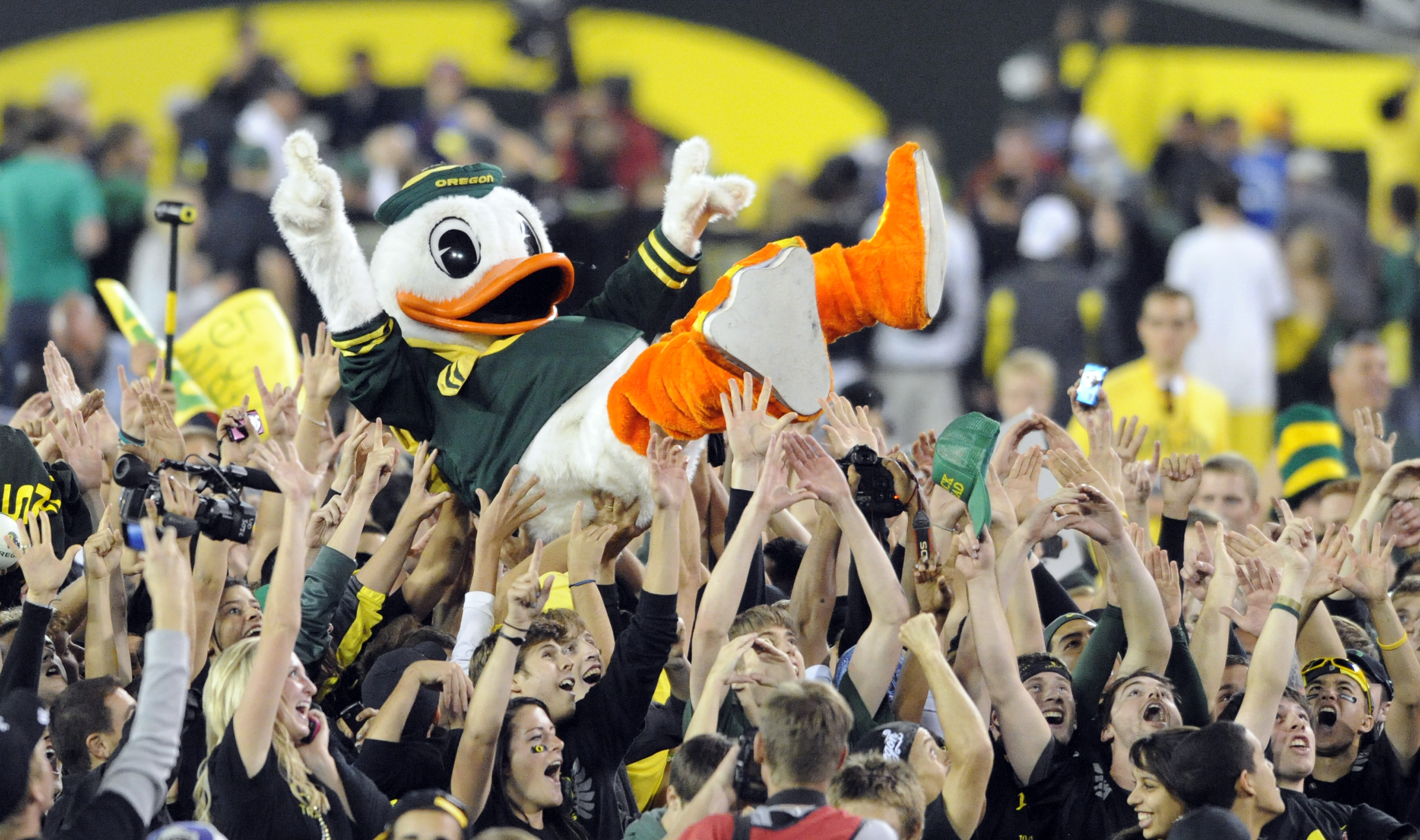EUGENE, OR - OCTOBER 2: Puddles the Oregon Duck mascot is carried on the shoulders of fans on the feild of Autzen Stadium after the Oregon Ducks beat the Stanford Cardinal 52-31 at Autzen Stadium on October 2, 2010 in Eugene, Oregon. (Photo by Steve Dykes