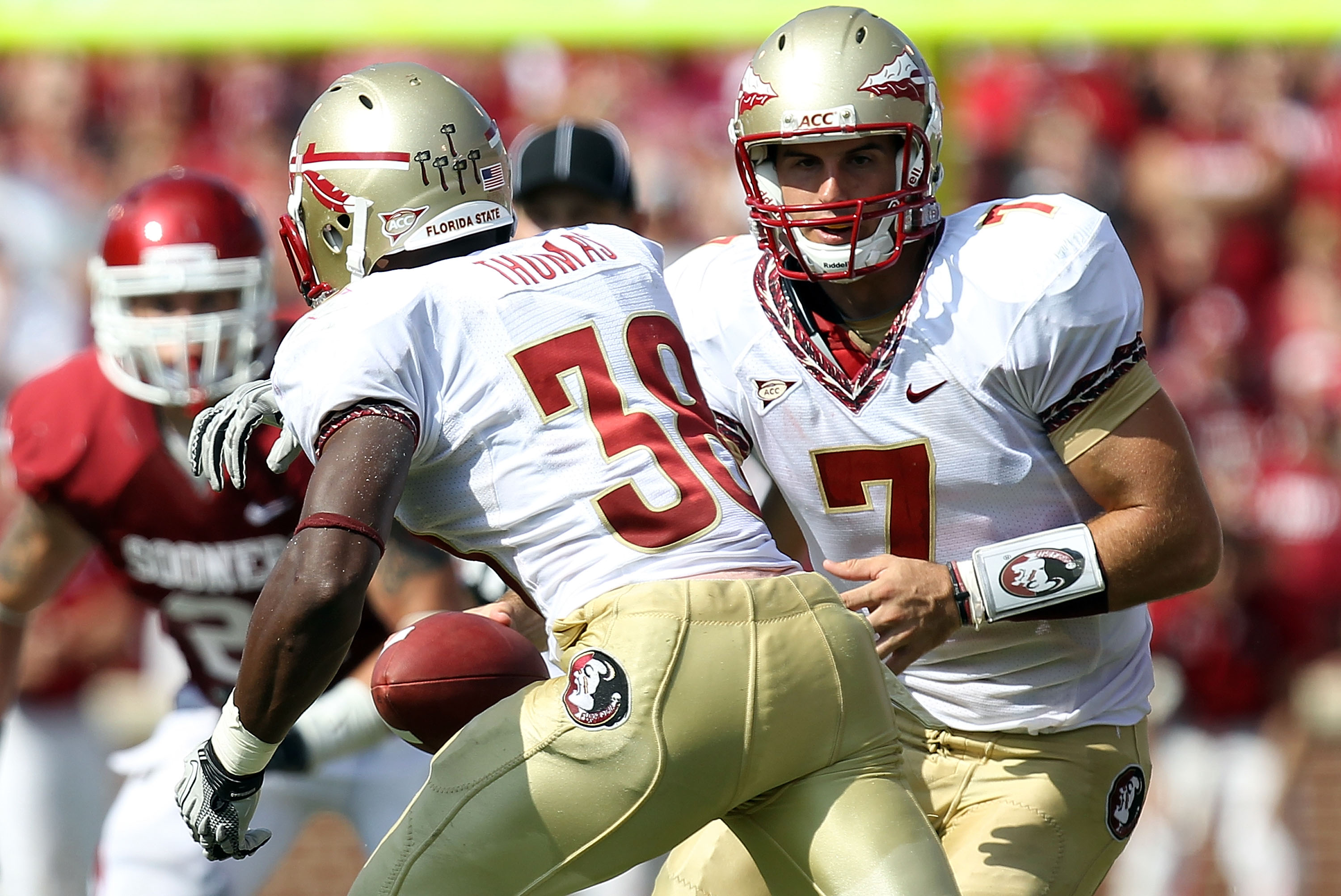 NORMAN, OK - SEPTEMBER 11: Quarterback Christian Ponder #7 of the Florida State Seminoles hands the ball off to Jermaine Thomas #38 against the Oklahoma Sooners at Gaylord Family Oklahoma Memorial Stadium on September 11, 2010 in Norman, Oklahoma. (Phot