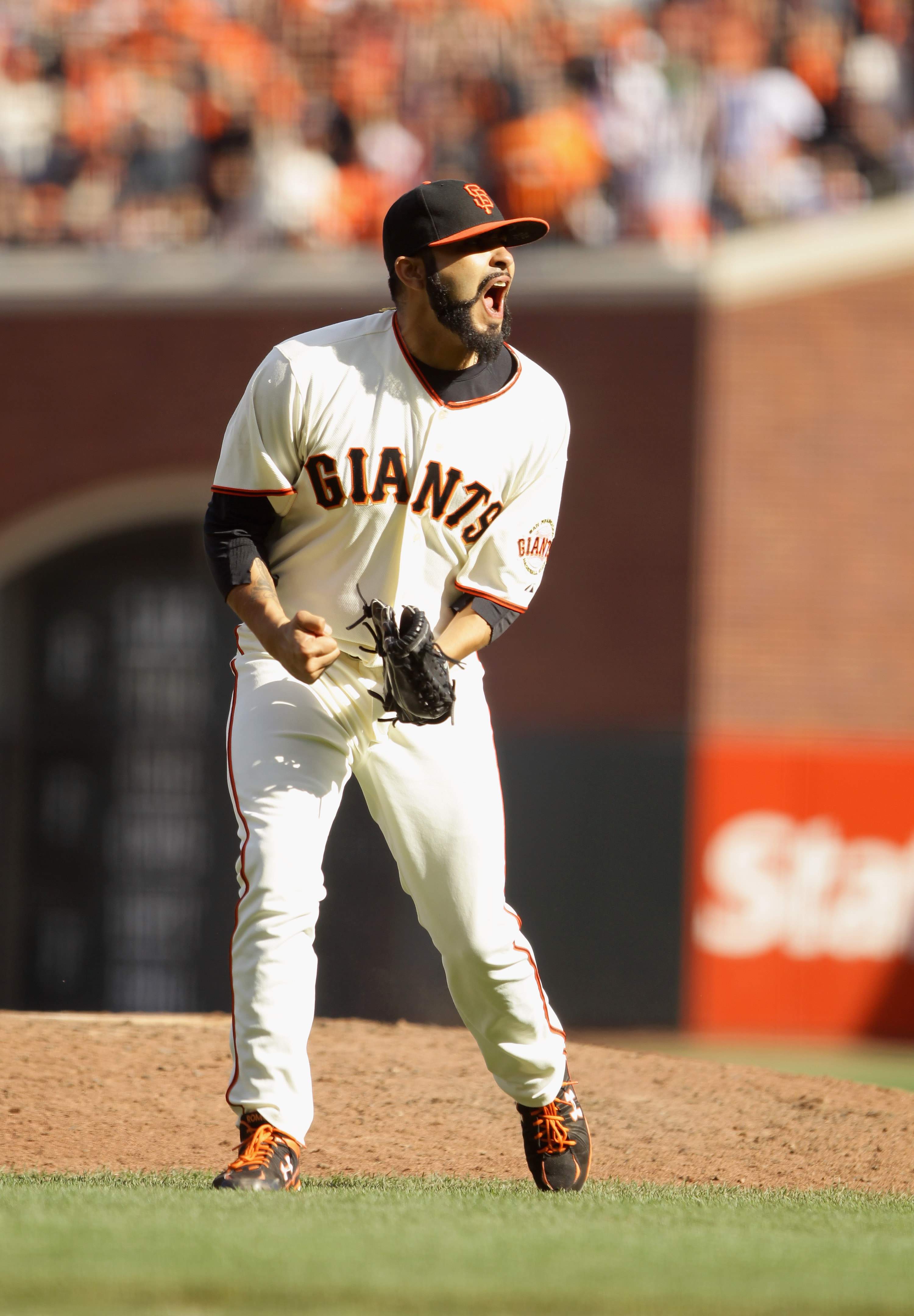 SAN FRANCISCO - OCTOBER 03:  Sergio Romo #45 of the San Francisco Giants celebrates after the end of the top of the eighth inning of their game against the San Diego Padres at AT&T Park on October 3, 2010 in San Francisco, California.  (Photo by Ezra Shaw