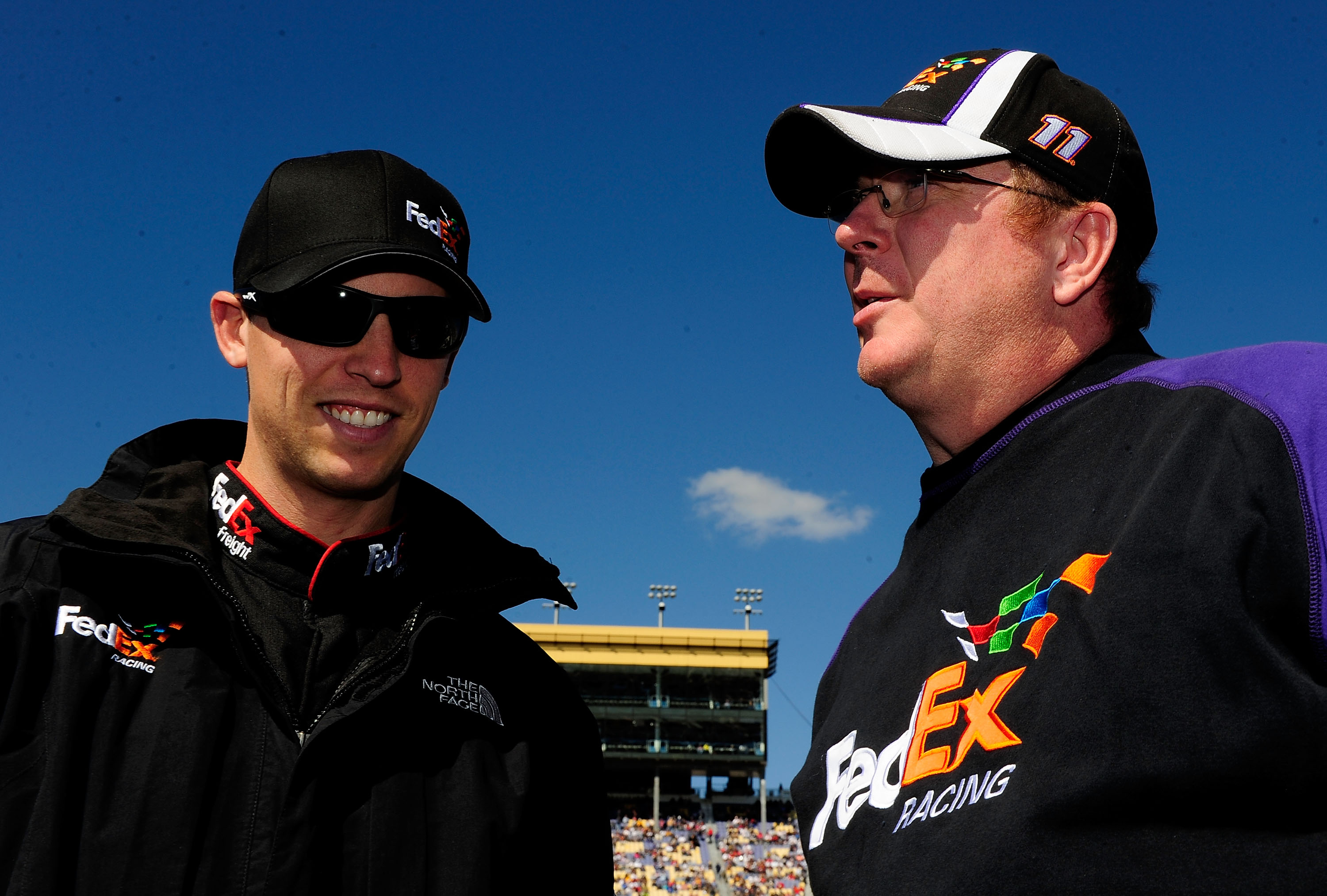 KANSAS CITY, KS - OCTOBER 03:  Denny Hamlin, driver of the #11 FedEx Toyota, stands with crew chief Mike Ford during prerace for the NASCAR Sprint Cup Series Price Chopper 400 on October 3, 2010 in Kansas City, Kansas.  (Photo by Rusty Jarrett/Getty Image