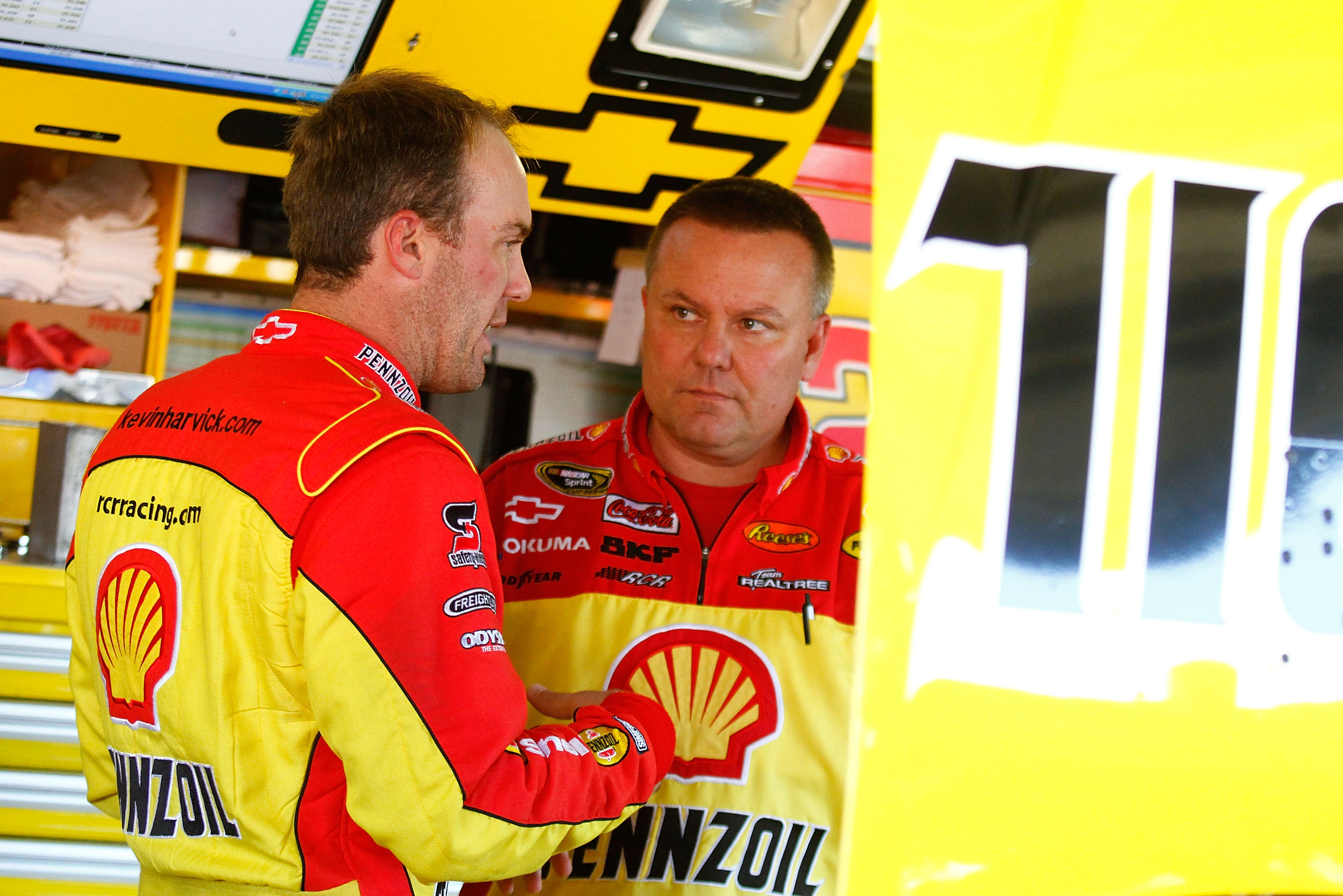 KANSAS CITY, KS - OCTOBER 01:  Kevin Harvick (L), driver of the #29 Shell/Pennzoil Chevrolet speaks with crew chief Gil Martin (R), during practice for the NASCAR Sprint Cup Series Price Chopper 400 on October 1, 2010 in Kansas City, Kansas.  (Photo by Ja