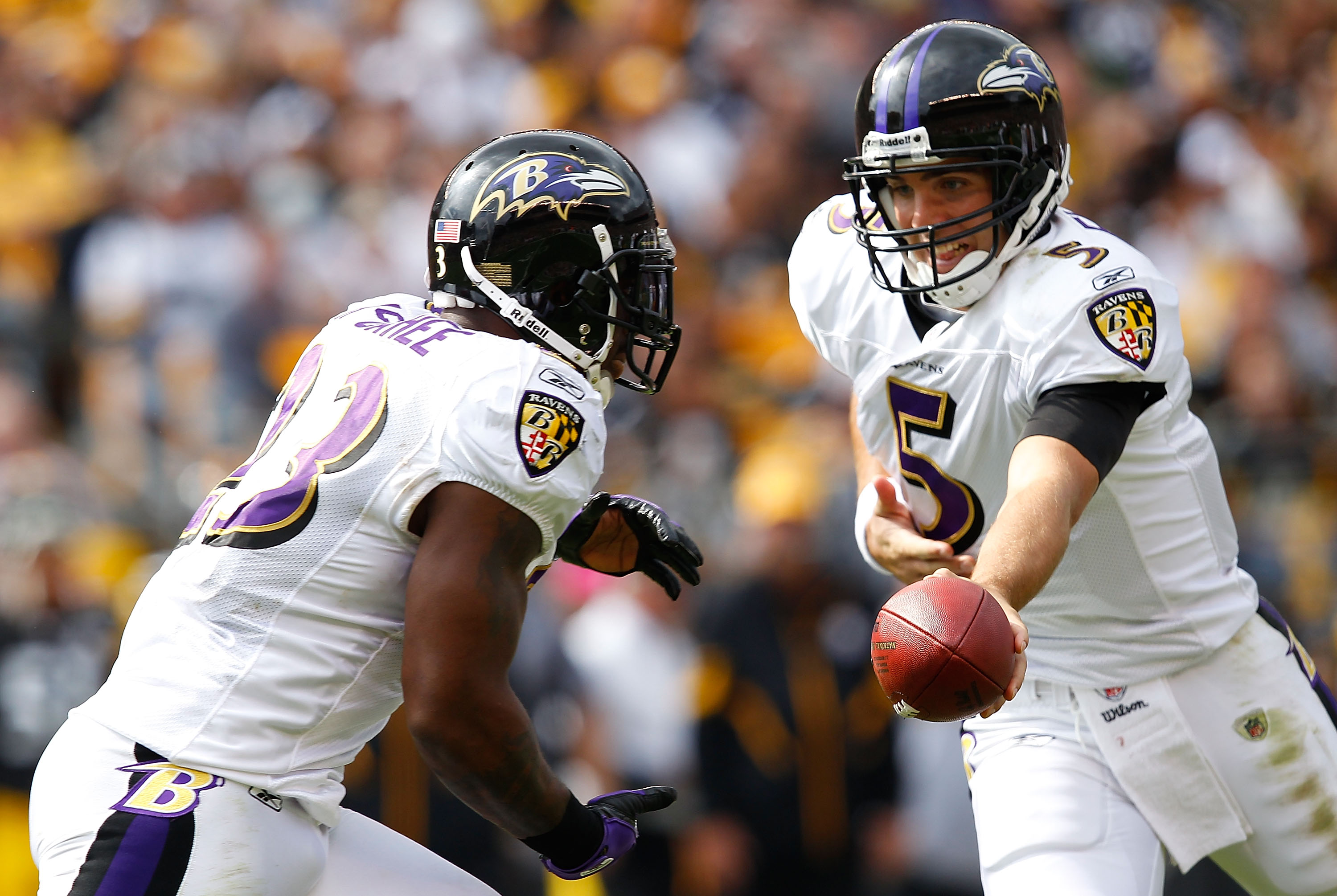 PITTSBURGH - OCTOBER 03:  Joe Flacco #5 of the Baltimore Ravens hands the ball off to teammate Willis McGahee #23 during the game against the Pittsburgh Steelers on October 3, 2010 at Heinz Field in Pittsburgh, Pennsylvania.  (Photo by Jared Wickerham/Get