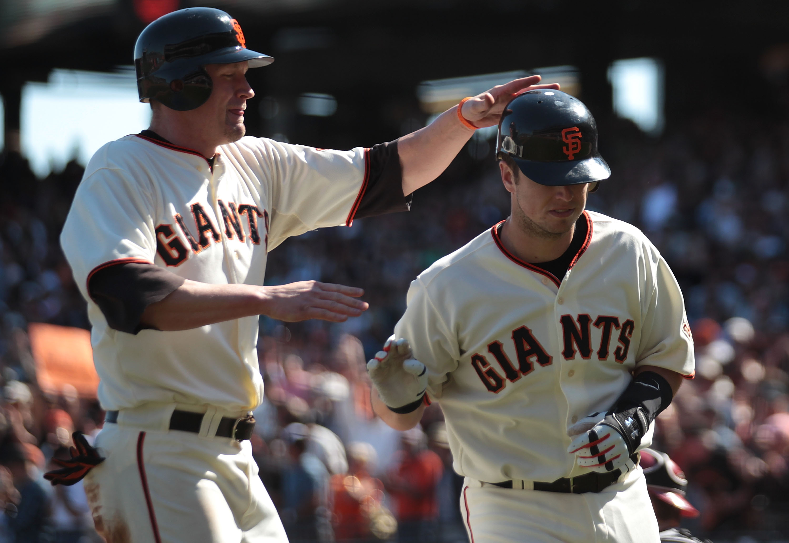 SAN FRANCISCO - SEPTEMBER 30:  Buster Posey #28 of the San Francisco Giants celebrates with Aubrey Huff #17 after hitting a two run home run in sixth inning against the Arizona Diamondbacks during a Major League Baseball game at AT&T Park on September 30,