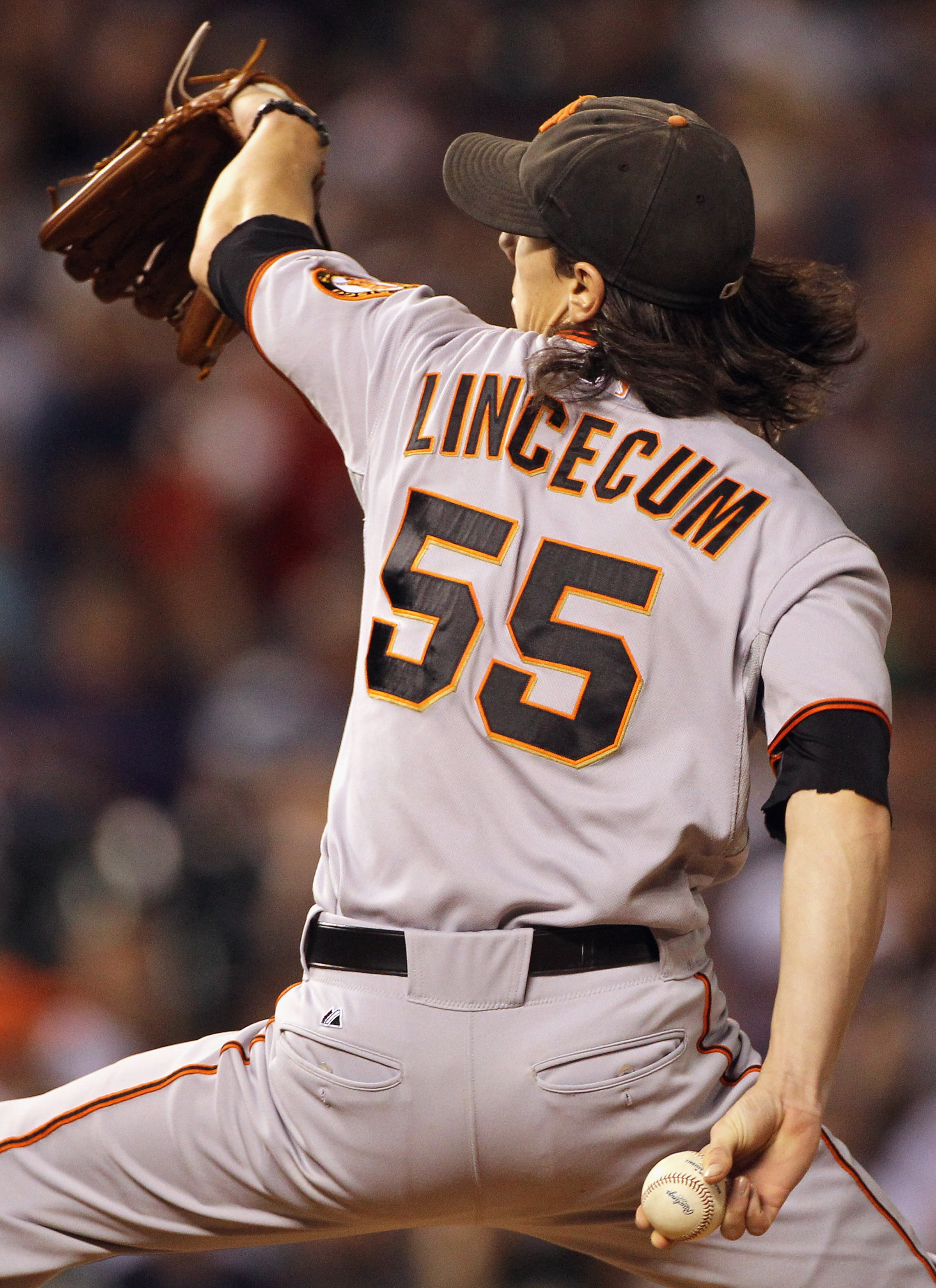 DENVER - SEPTEMBER 24:  Starting pitcher Tim Lincecum #55 of the San Francisco Giants delivers against the Colorado Rockies at Coors Field on September 24, 2010 in Denver, Colorado. Lincecum earned the win as the Giants defeated the Rockies 2-1.  (Photo b