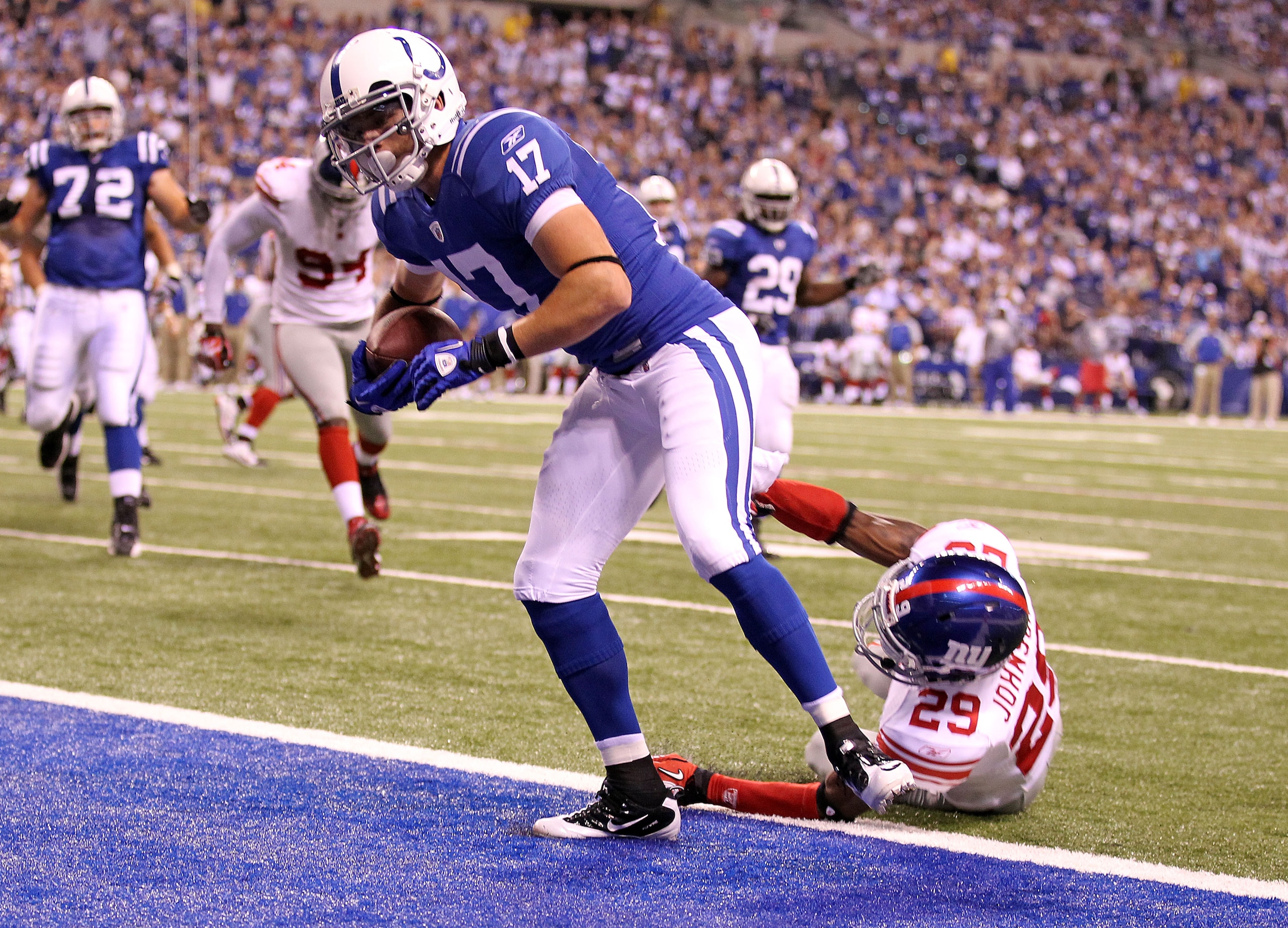 INDIANAPOLIS - SEPTEMBER 19: Austin Collie #17 of the Indianapolis Colts scores a touchdown while defended by D.J. Johnson #29 of the New York Giants during the NFL game at Lucas Oil Stadium on September 19, 2010 in Indianapolis, Indiana. (Photo by And INDIANAPOLIS - SEPTEMBER 19: Austin Collie #17 of the Indianapolis Colts scores a touchdown while defended by D.J. Johnson #29 of the New York Giants during the NFL game at Lucas Oil Stadium on September 19, 2010 in Indianapolis, Indiana. (Photo by And
