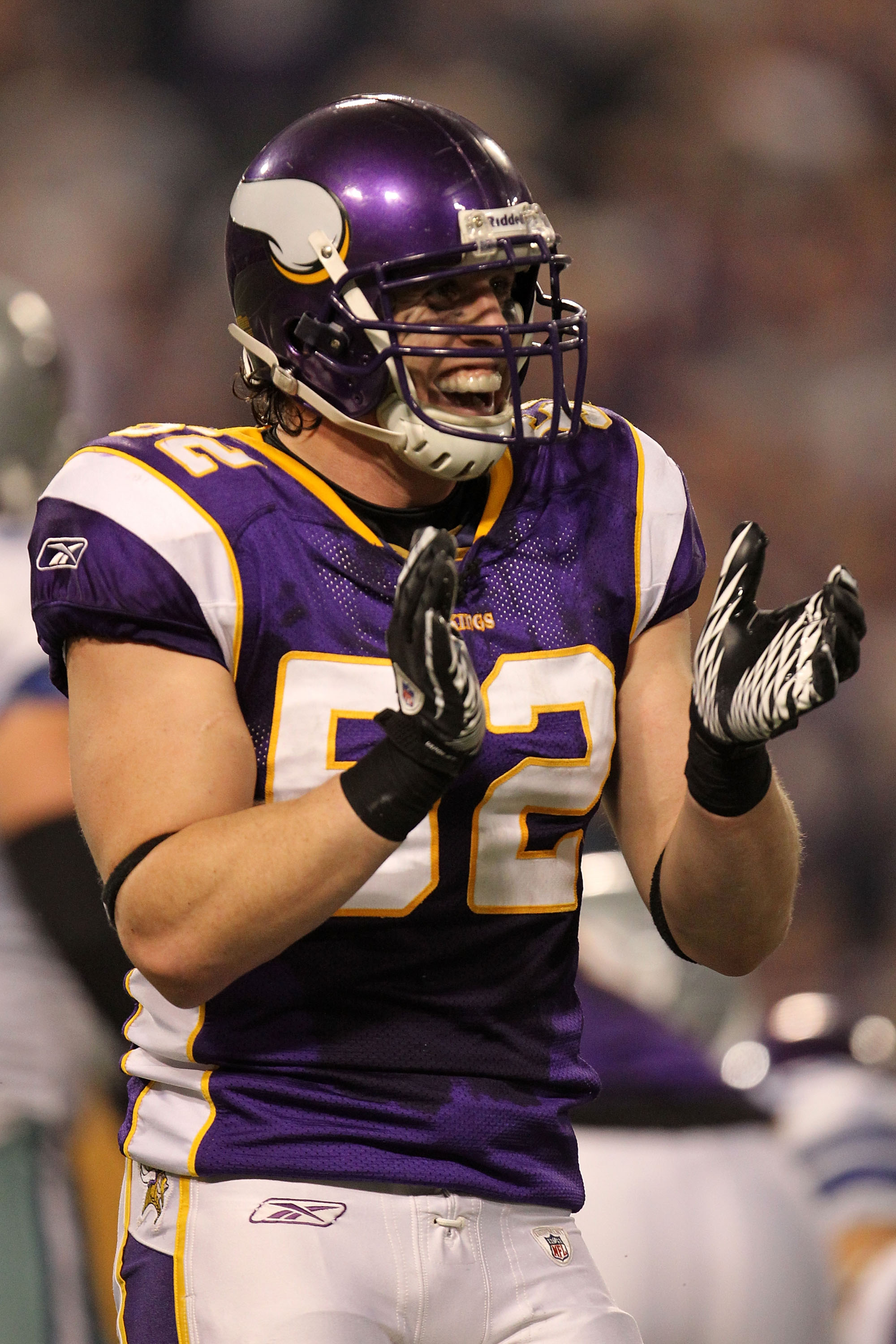 Minnesota Vikings Chad Greenway celebrates his 37 yard interception return  for a touchdown against the New York Giants in the fourth quarter with  teammates E.J. Henderson (56) and Ben Leber (51) at