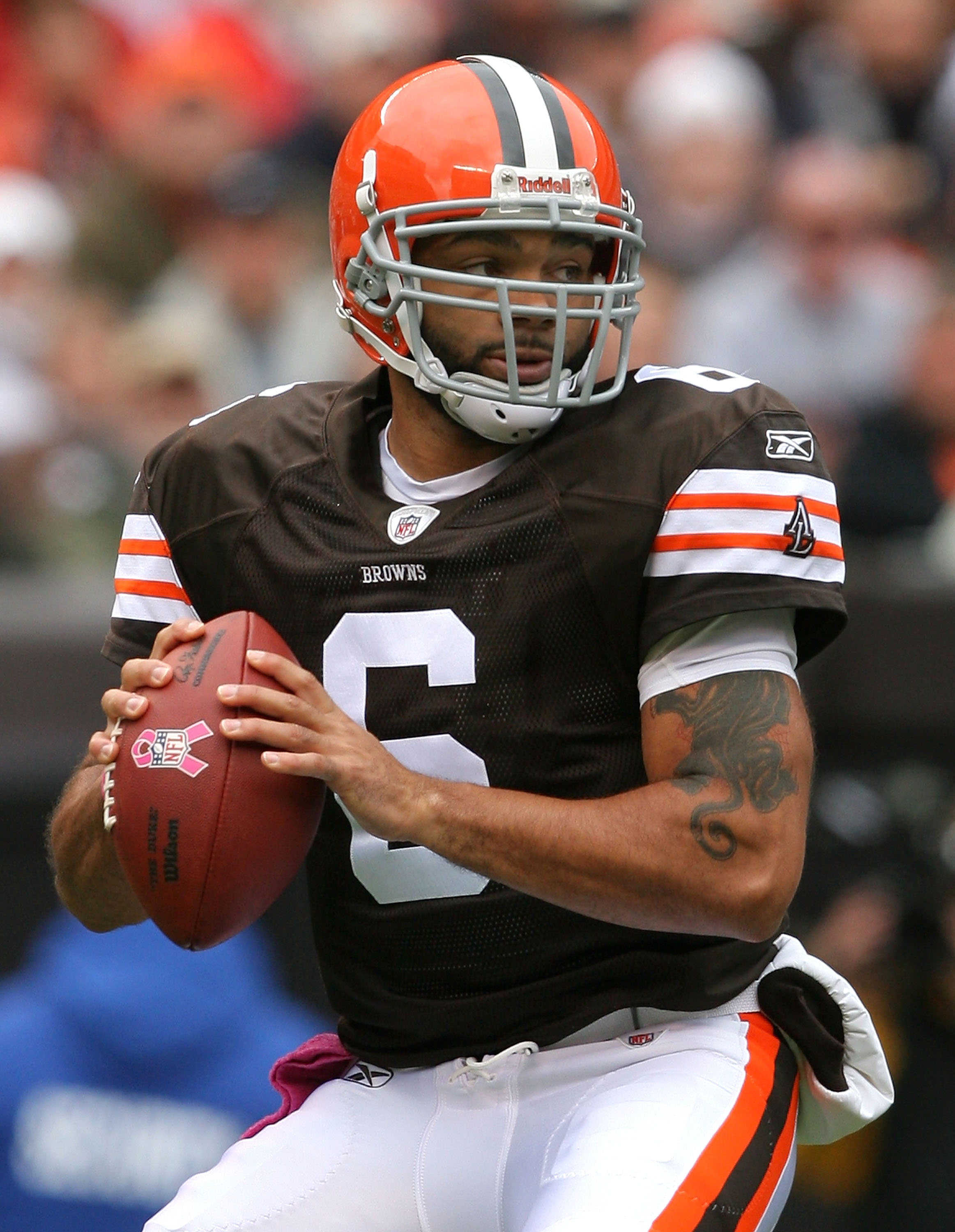 Cleveland Browns quarterback Charlie Frye (9) fumbles the football as he is  hit by Baltimore Ravens defensive end Terrell Suggs in the second quarter  at Cleveland Browns Stadium in Cleveland, OH on