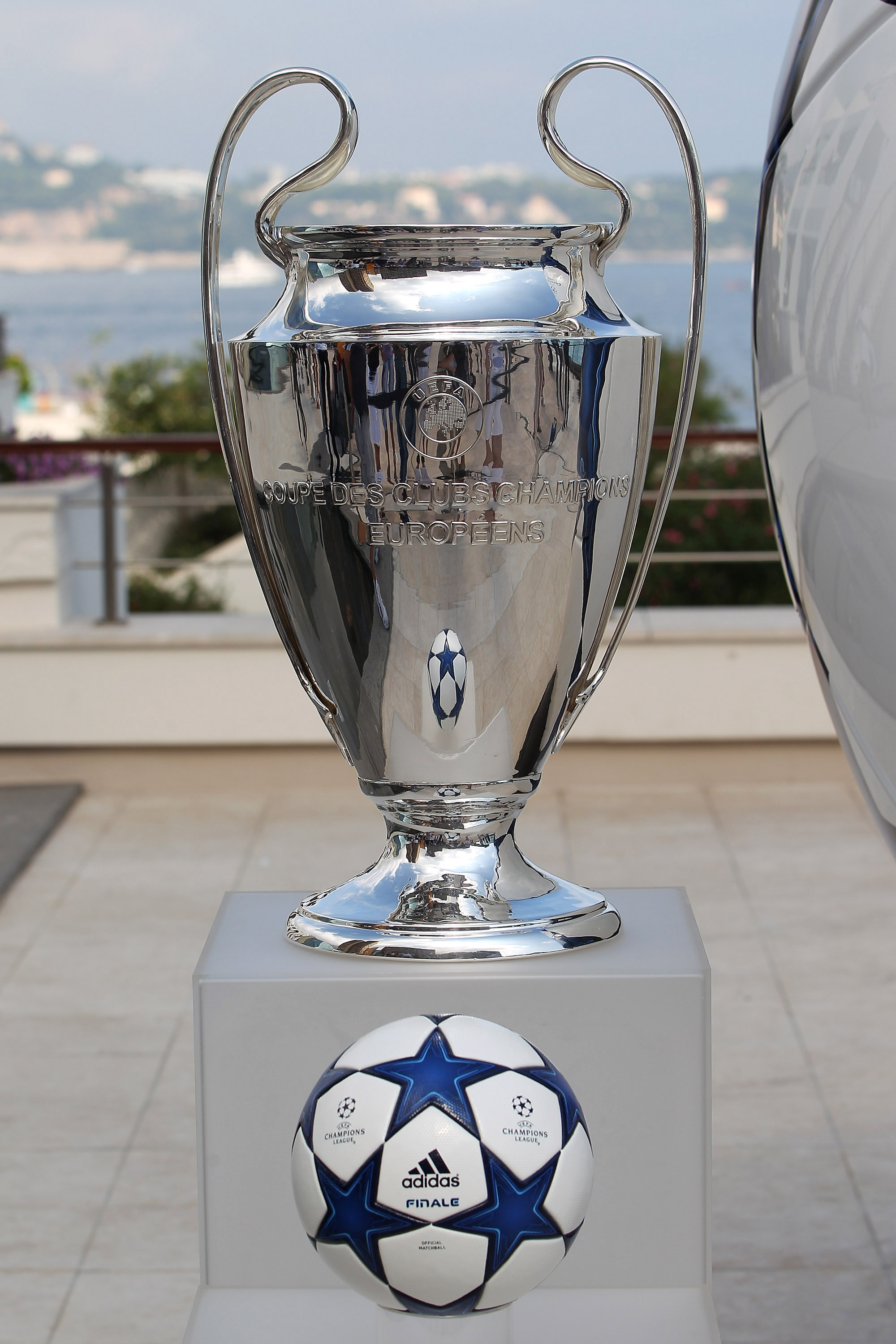 MONACO - AUGUST 26:  An Adidas ball on show alongside the Champions League trophy during the UEFA Champions League Group Stage draw at the Grimaldi Forum on August 26, 2010 in Monaco, Monaco.  (Photo by Michael Steele/Getty Images)