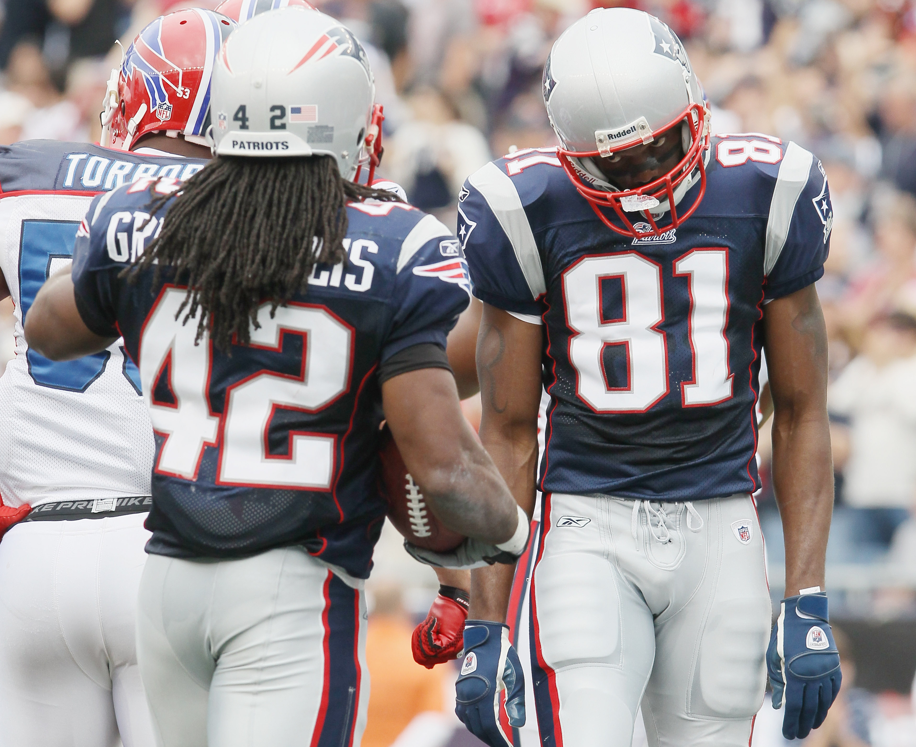 New England Patriots wide receiver Randy Moss stands on the field while the  team stretches before practice begins at the NFL football team's facility  in Foxborough, Mass., Wednesday afternoon, Jan. 16, 2008.