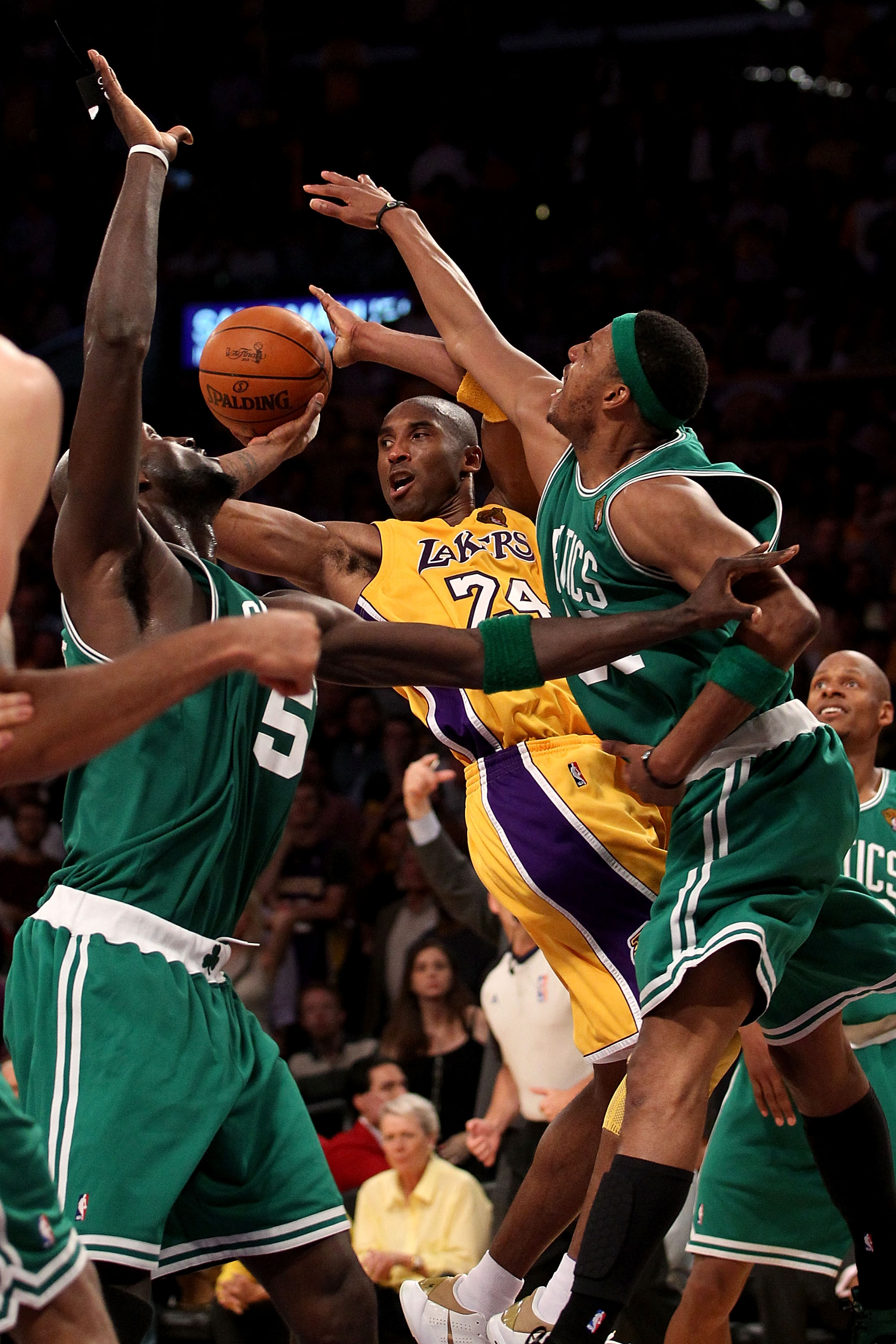 LOS ANGELES, CA - JUNE 17:  Kobe Bryant #24 of the Los Angeles Lakers passes under pressure from Kevin Garnett #5 and Paul Pierce #34 of the Boston Celtics in Game Seven of the 2010 NBA Finals at Staples Center on June 17, 2010 in Los Angeles, California.