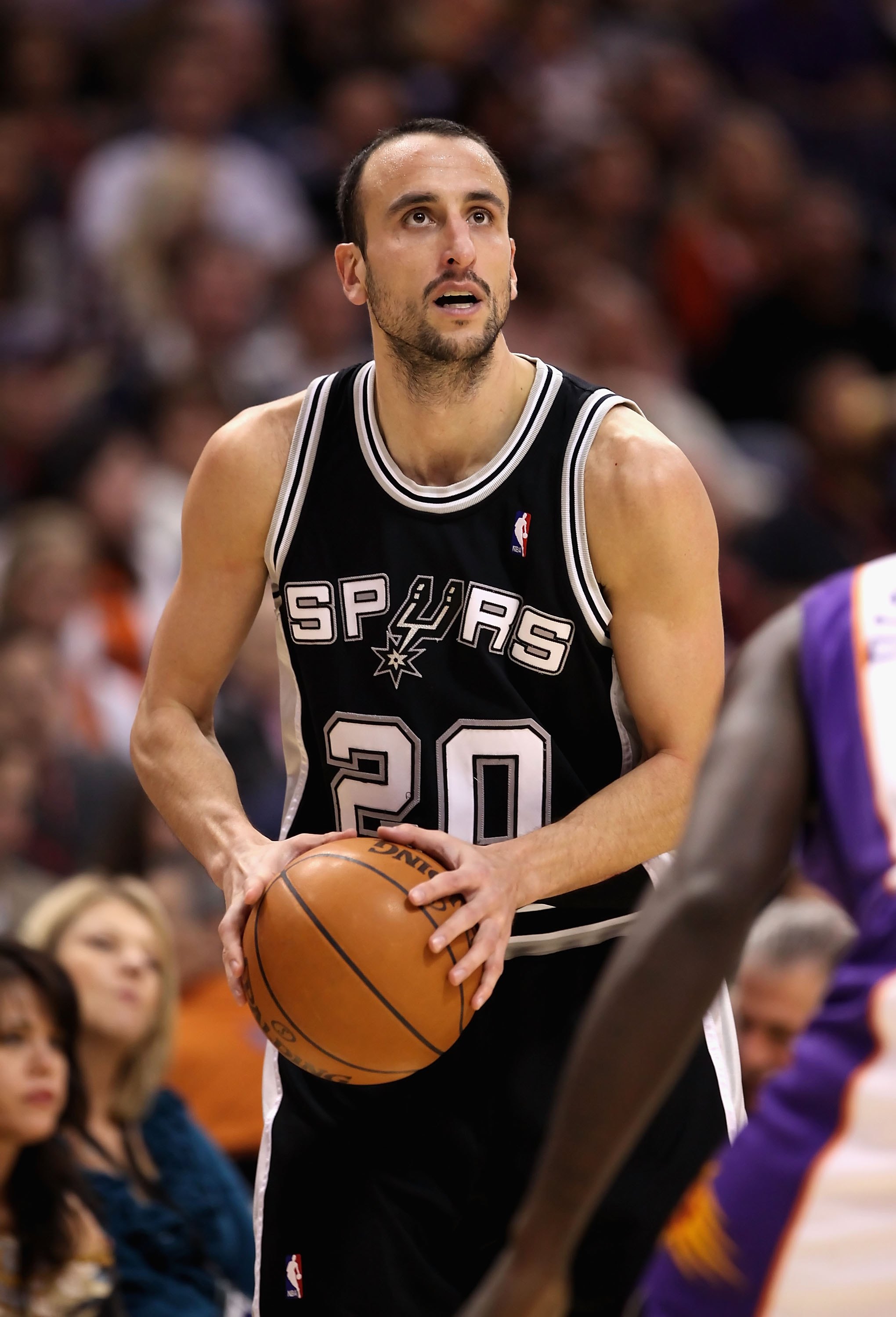 PHOENIX - DECEMBER 15:  Manu Ginobili #20 of the San Antonio Spurs looks to shoot during the NBA game against the Phoenix Suns at US Airways Center on December 15, 2009 in Phoenix, Arizona. The Suns defeated the Spurs 116-104. NOTE TO USER: User expressly