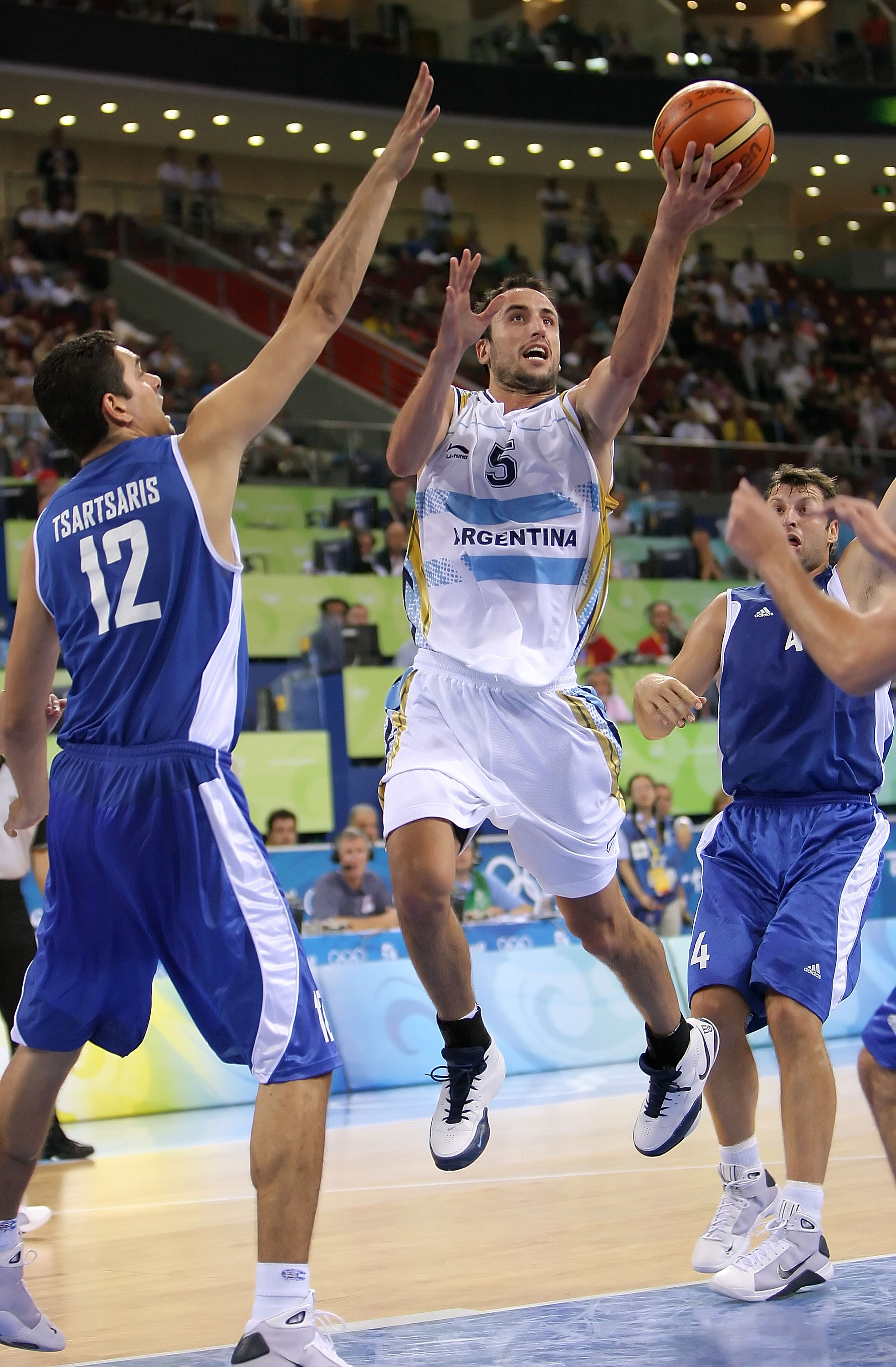 BEIJING - AUGUST 20:  Manu Ginobili #5 of Argentina drives to the basket over the defense of Konstantinos Tsartsaris #12 of Greece during the men's basketball quarterfinal game at the Olympic Basketball Gymnasium during Day 12 of the Beijing 2008 Olympic
