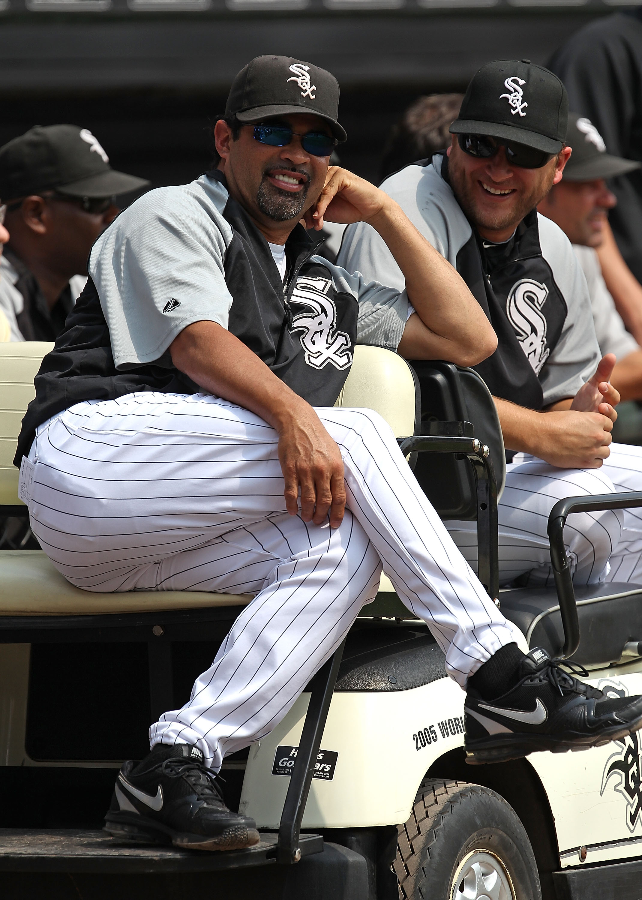 CHICAGO - AUGUST 29: Manager Ozzie Guillen #13 (L) and Mark Buehrle #56 of the Chicago White Sox enjoy a ceremony retiring former player Frank Thomas' number 35 before a game against the New York Yankees at U.S. Cellular Field on August 29, 2010 in Chicag