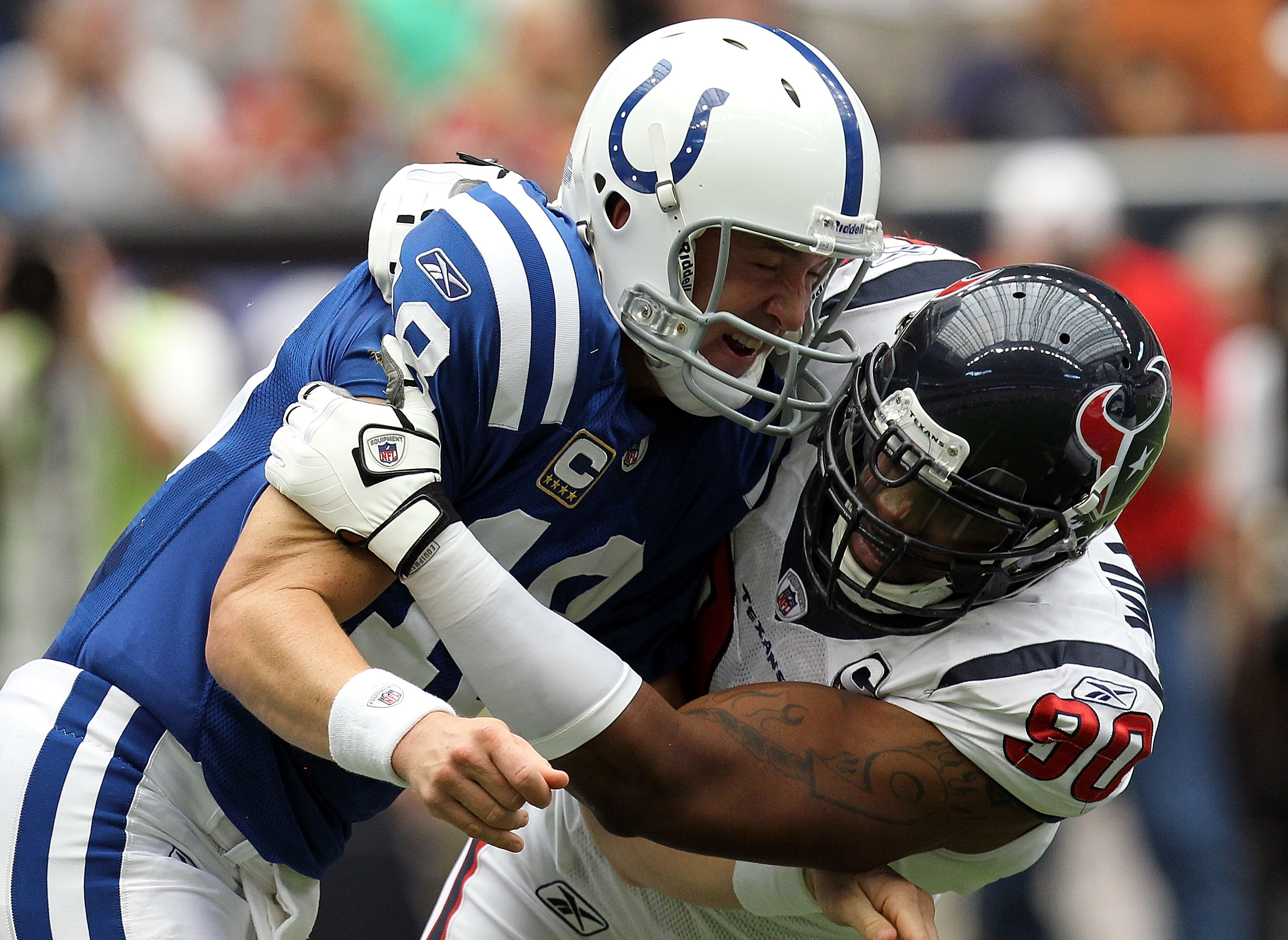 HOUSTON - SEPTEMBER 12:  Quarterback Peyton Manning #18 of the Indianapolis Colts is tackled by Mario Williams #90 of the Houston Texans during the NFL season opener at Reliant Stadium on September 12, 2010 in Houston, Texas.  (Photo by Ronald Martinez/Ge