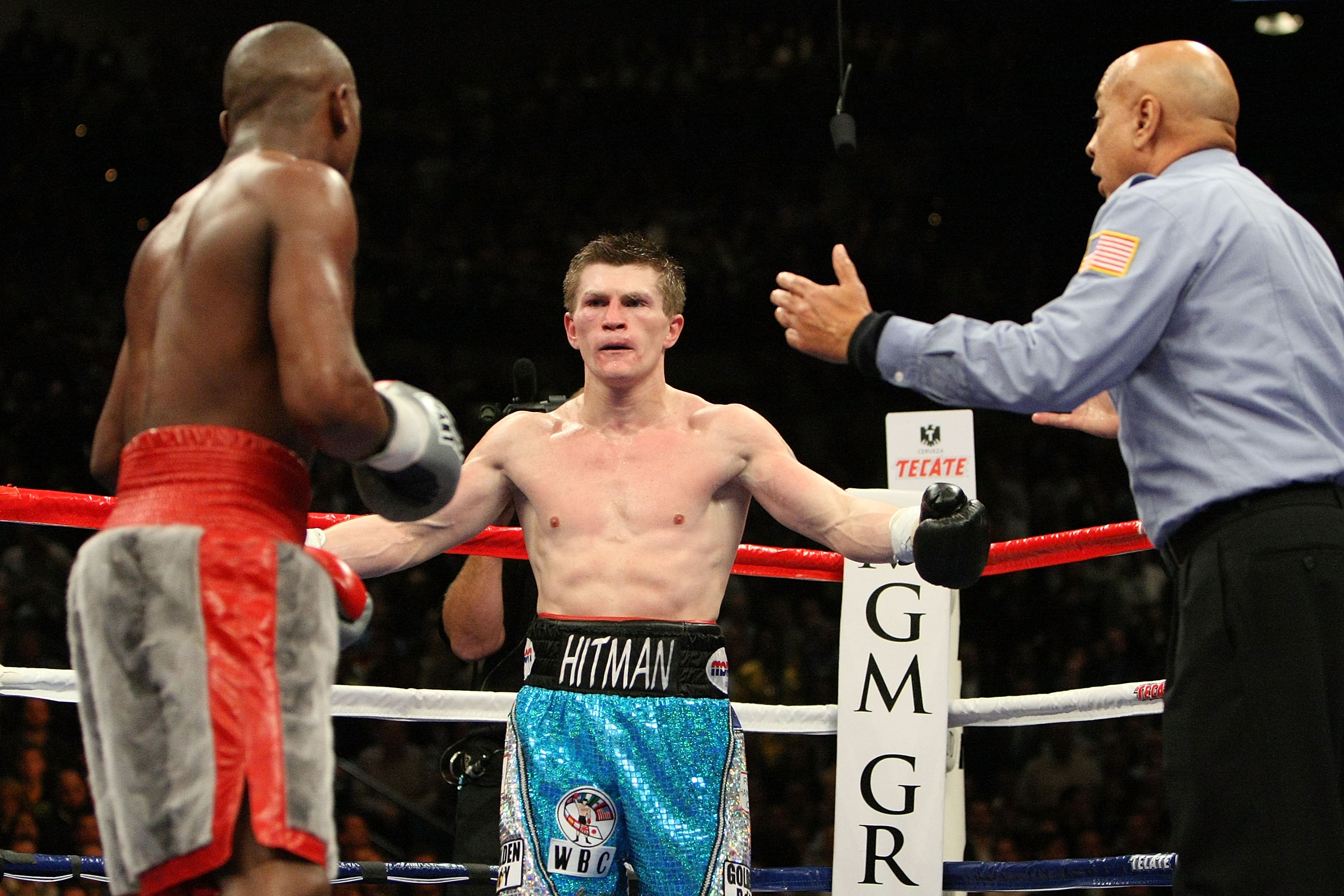LAS VEGAS - DECEMBER 08:  (M) Ricky Hatton of England throws his arms out as he looks over at Floyd Mayweather Jr. and referee Joe Cortez during their WBC world welterweight championship fight at the MGM Grand Garden Arena on December 8, 2007 in Las Vegas
