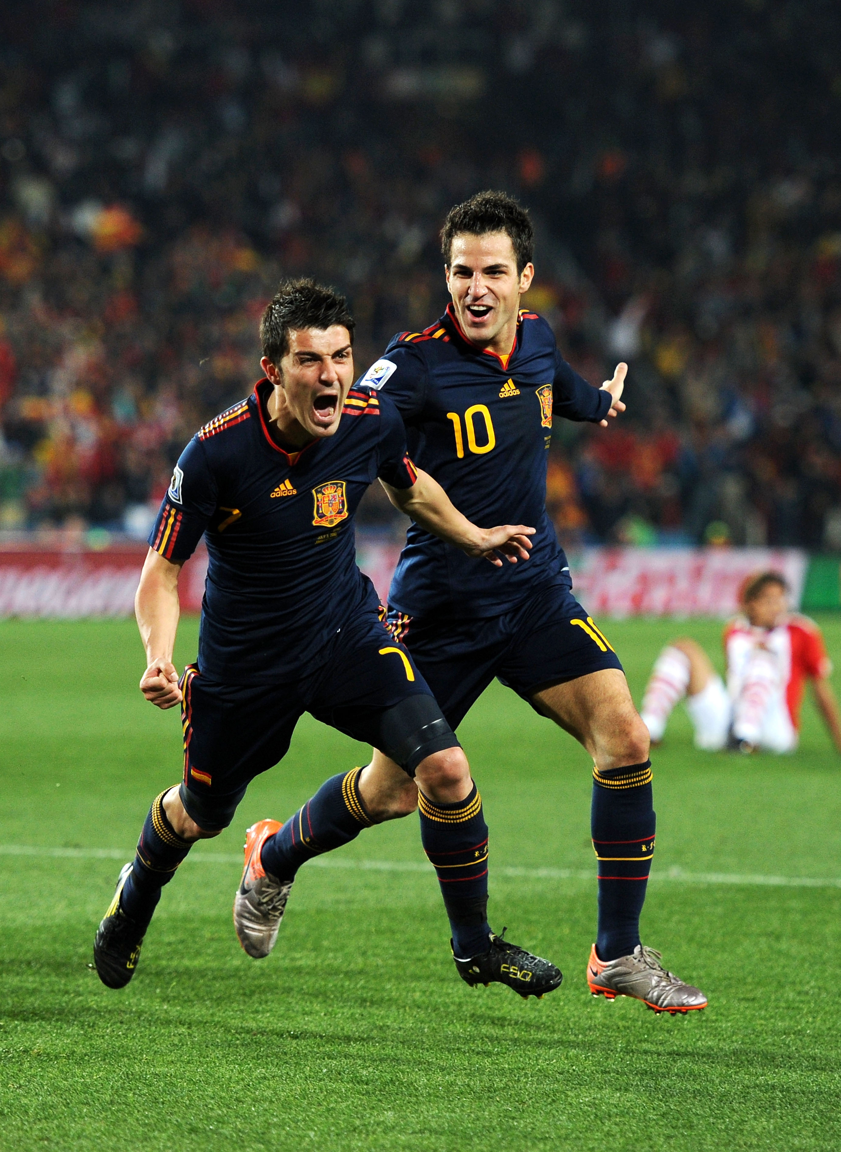 JOHANNESBURG, SOUTH AFRICA - JULY 03:  David Villa of Spain celebrates after he scores his side's first goal with team mate Francesc Fabregas (R) during the 2010 FIFA World Cup South Africa Quarter Final match between Paraguay and Spain at Ellis Park Stad