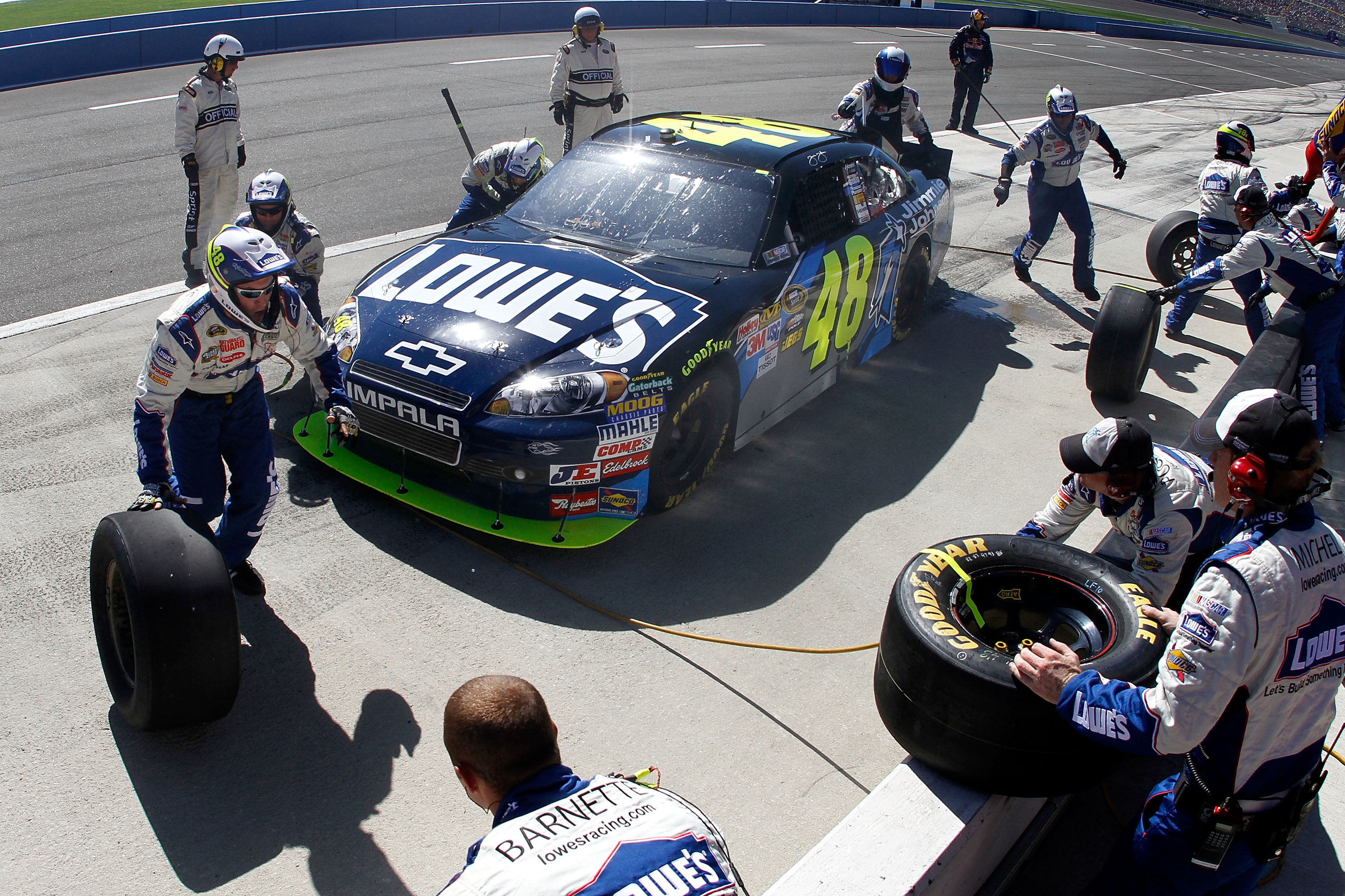 FONTANA, CA - OCTOBER 10:  Jimmie Johnson, driver of the #48 Lowe's/Jimmie Johnson Foundation Chevrolet, makes a pit stop during the NASCAR Sprint Cup Series Pepsi Max 400 on October 10, 2010 in Fontana, California.  (Photo by Jason Smith/Getty Images for