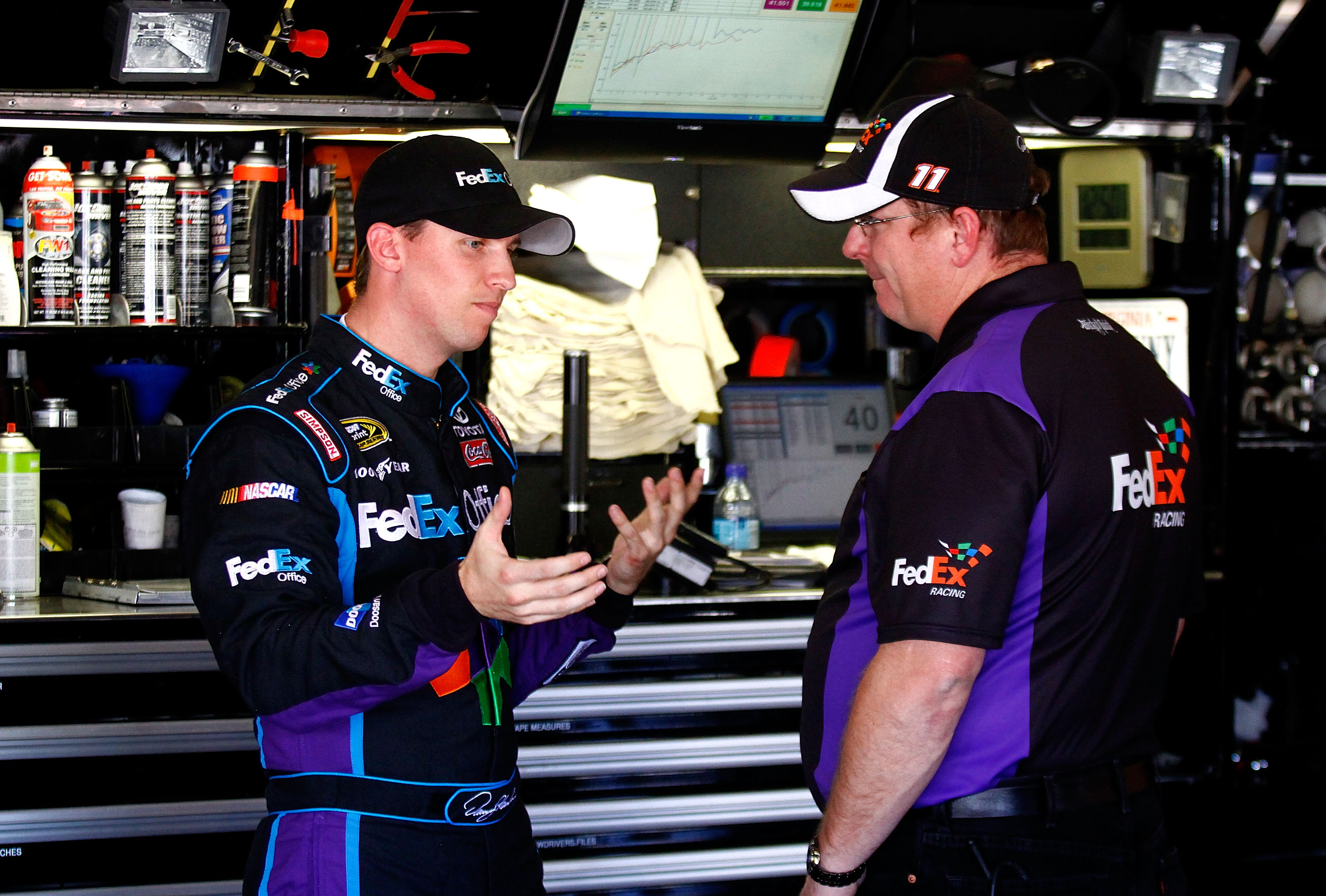 FONTANA, CA - OCTOBER 08:  (L-R) Denny Hamlin, driver of the #11 FedEx Office Toyota, speaks with crew chief Michael Ford during practice for the NASCAR Sprint Cup Series Pepsi Max 400 on October 8, 2010 in Fontana, California.  (Photo by Jason Smith/Gett