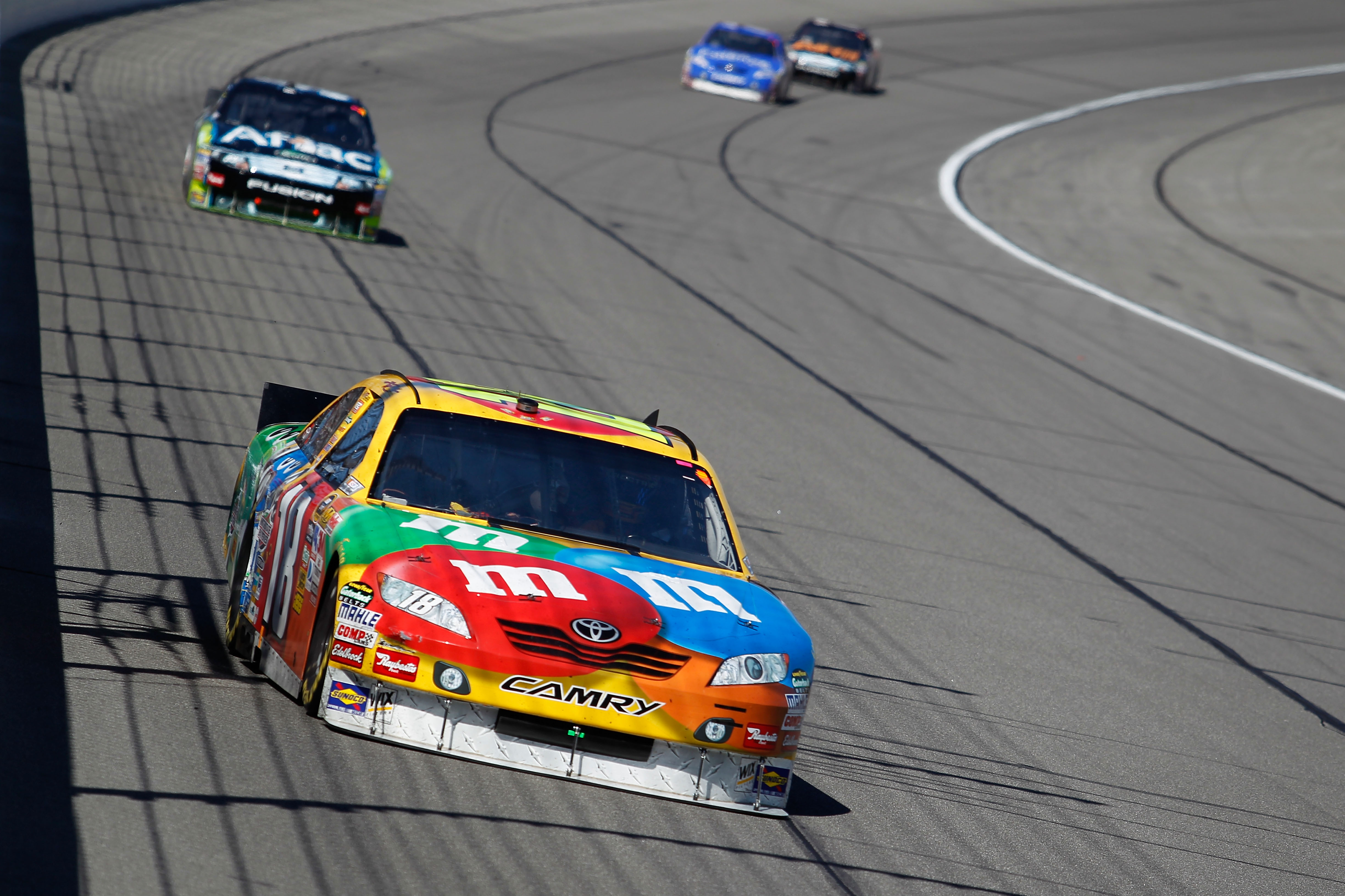 KANSAS CITY, KS - OCTOBER 03:  Kyle Busch, driver of the #18 M&M's Toyota, leads a line of cars during the NASCAR Sprint Cup Series Price Chopper 400 on October 3, 2010 in Kansas City, Kansas.  (Photo by Todd Warshaw/Getty Images)