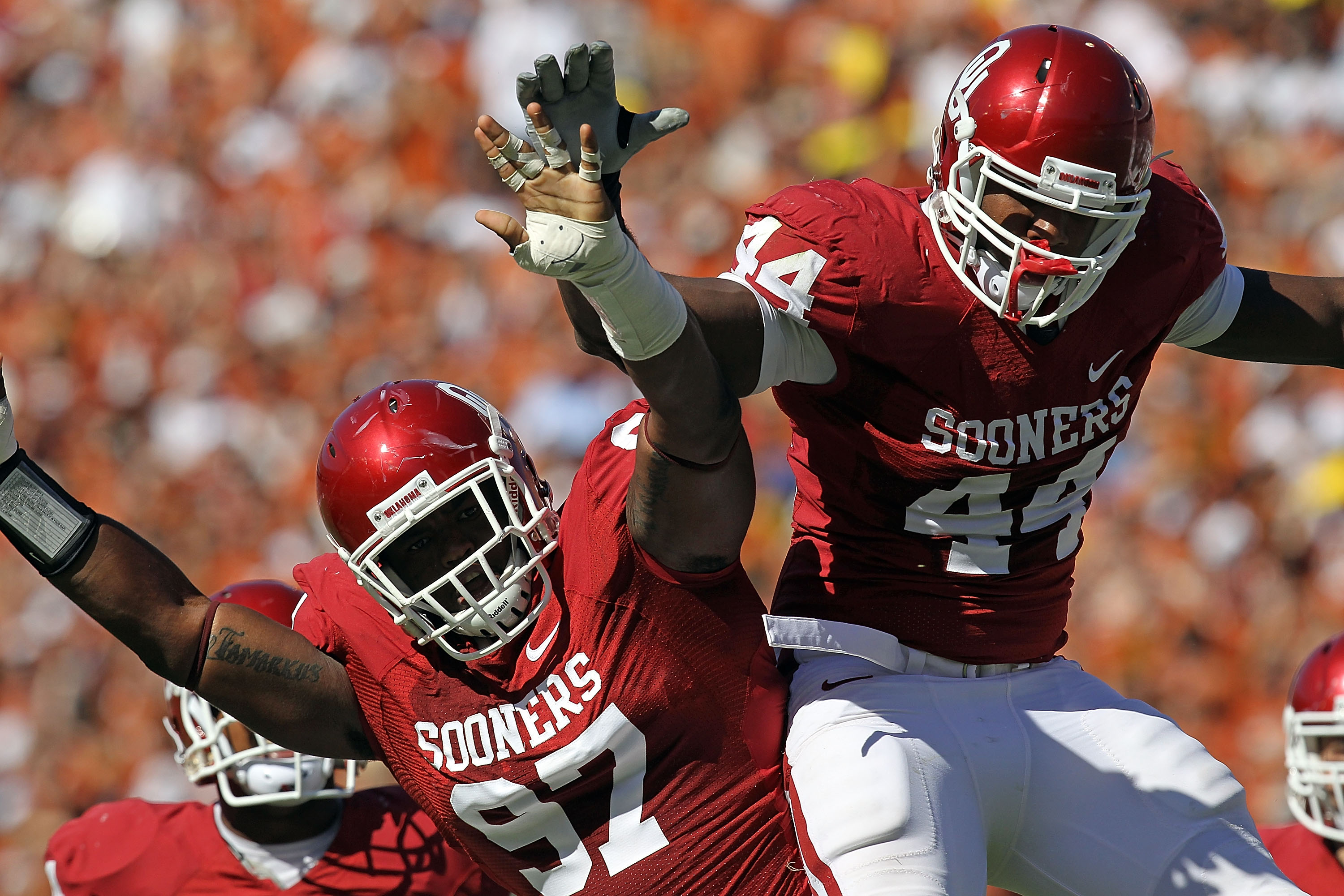 DALLAS - OCTOBER 02:  Jeremy Beal #44 and Jamarkus McFarland #97 of the Oklahoma Sooners celebrate a quarterback sack against the Texas Longhorns in the first quarter at the Cotton Bowl on October 2, 2010 in Dallas, Texas.  (Photo by Ronald Martinez/Getty