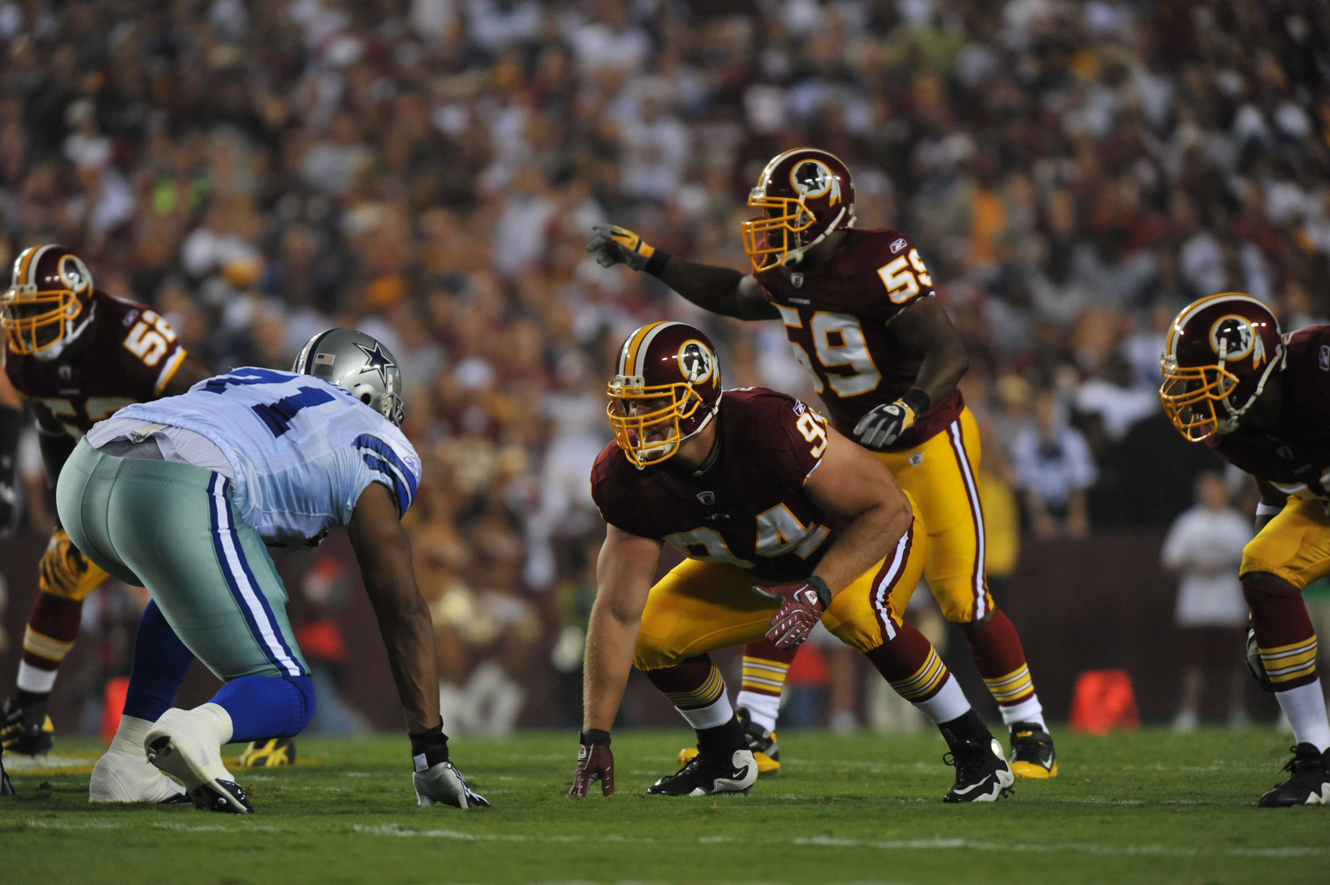 LANDOVER - SEPTEMBER 12: Adam Carriker #94 of the Washington Redskins defends during the NFL season opener against the Dallas Cowboys at FedExField on September 12, 2010 in Landover, Maryland. The Redskins defeated the Cowboys 13-7. (Photo by Larry Frenc