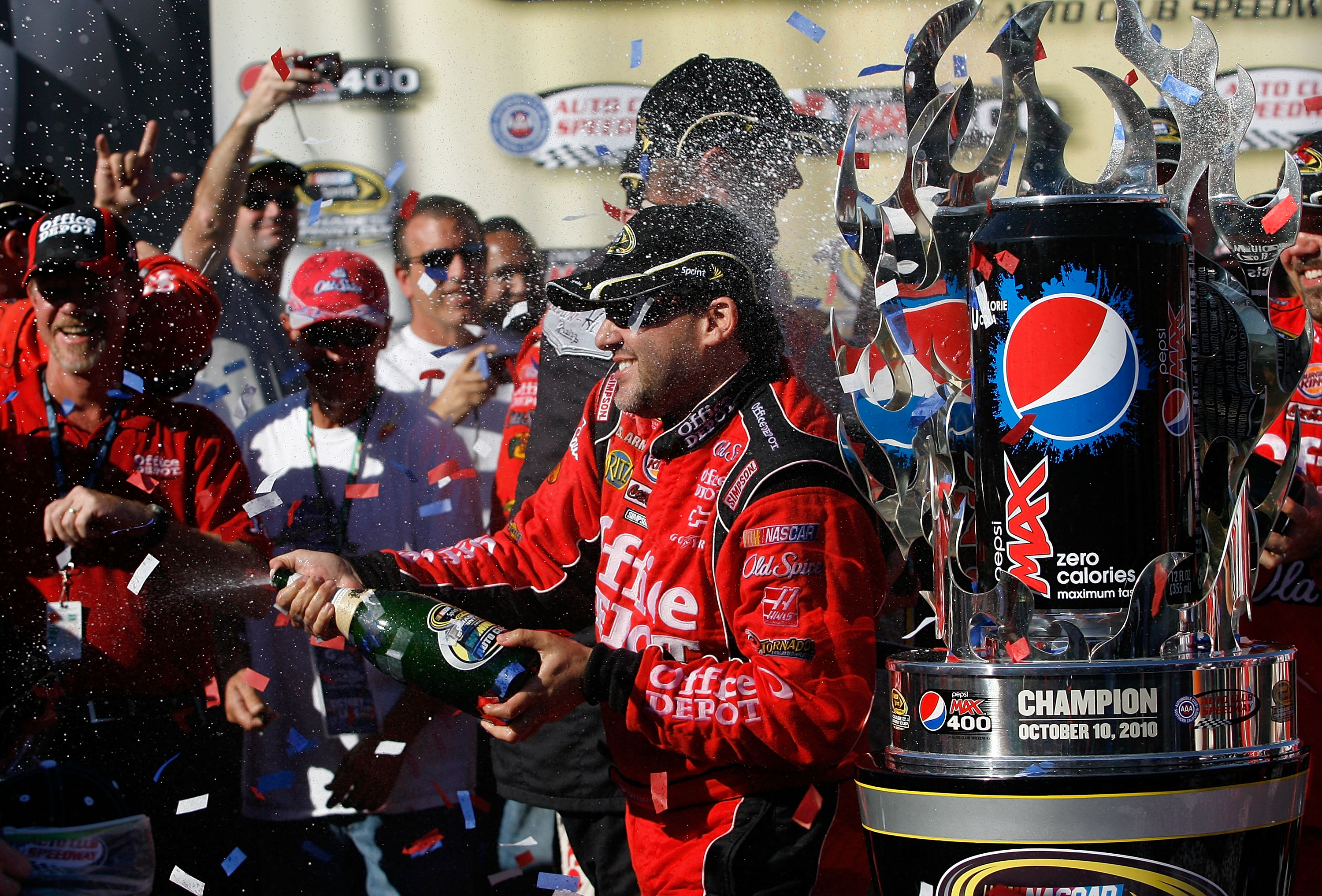 FONTANA, CA - OCTOBER 10:  Tony Stewart (R), driver of the #14 Office Depot Chevrolet, celebrates in victory lane after winning the NASCAR Sprint Cup Series Pepsi Max 400 on October 10, 2010 in Fontana, California.  (Photo by Tom Pennington/Getty Images f