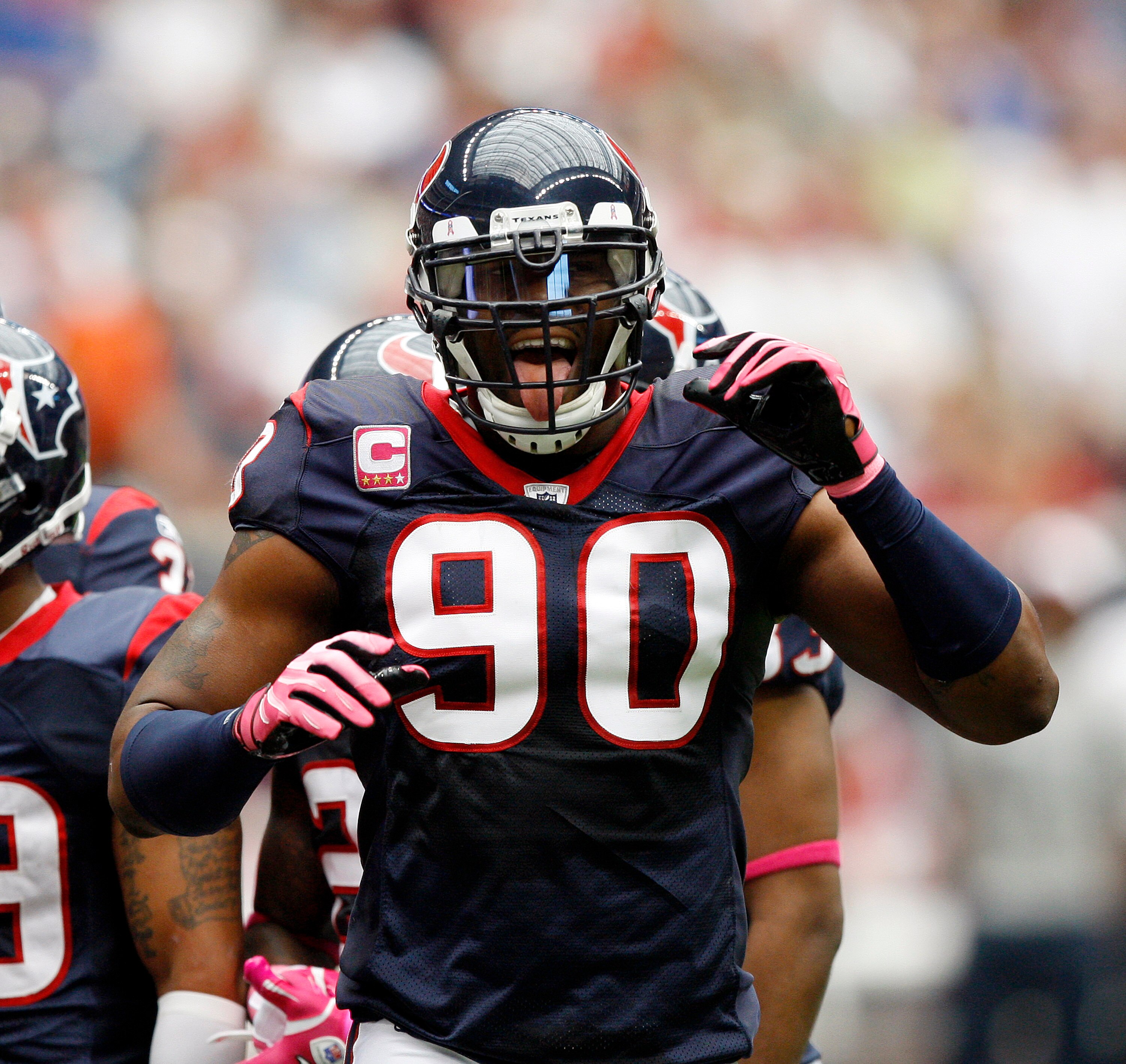 HOUSTON - OCTOBER 10:  Defensive end Mario Wiliiams of the Houston Texans tries to get the crowd into the game against the New York Giants at Reliant Stadium on October 10, 2010 in Houston, Texas.  (Photo by Bob Levey/Getty Images)