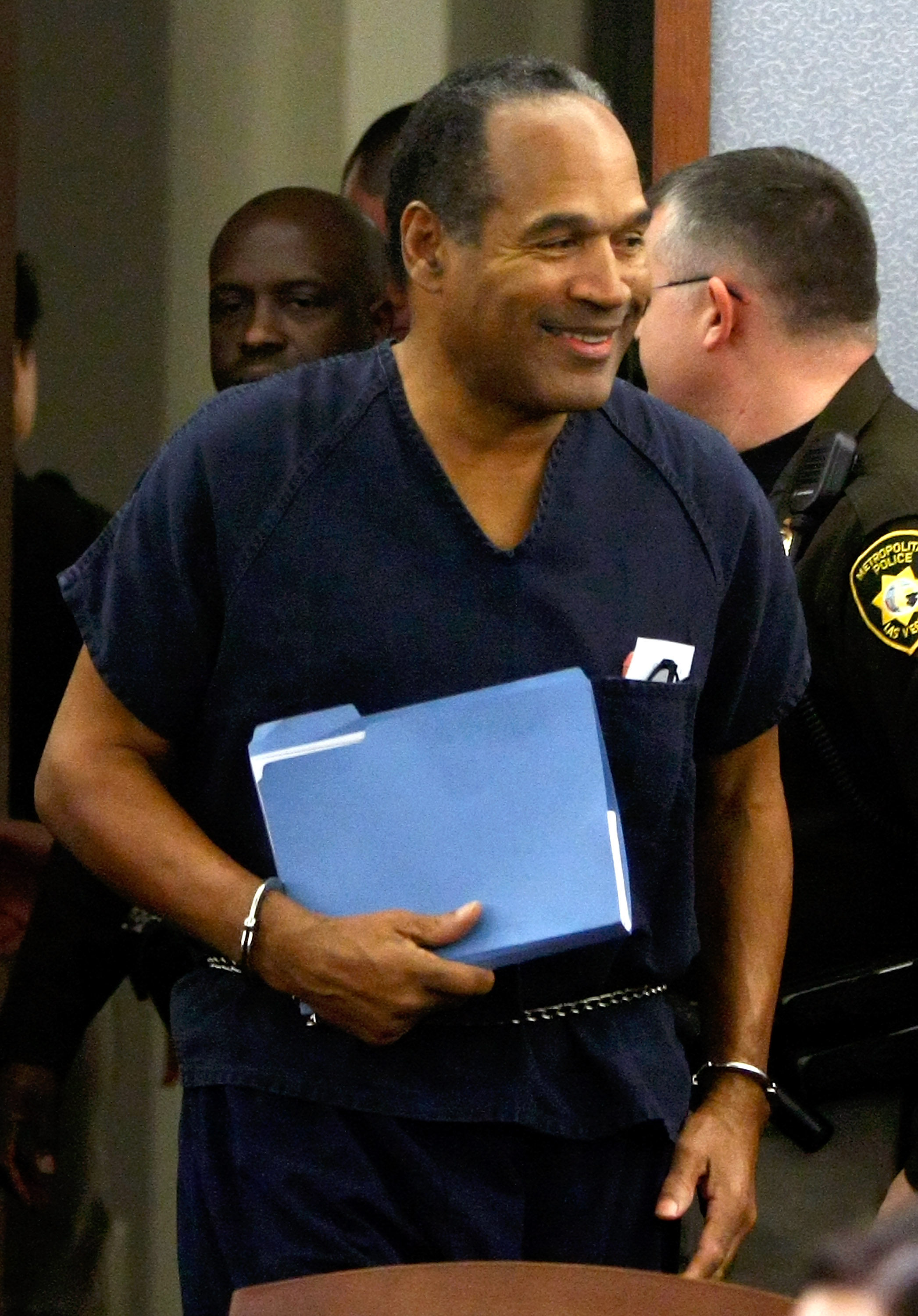 LAS VEGAS - DECEMBER 05:  O.J. Simpson smiles as he arrives in court for his sentencing hearing at the Clark County Regional Justice Center December 5, 2008 in Las Vegas, Nevada. Simpson and co-defendant Clarence 'C.J.' Stewart were sentenced on 12 charge