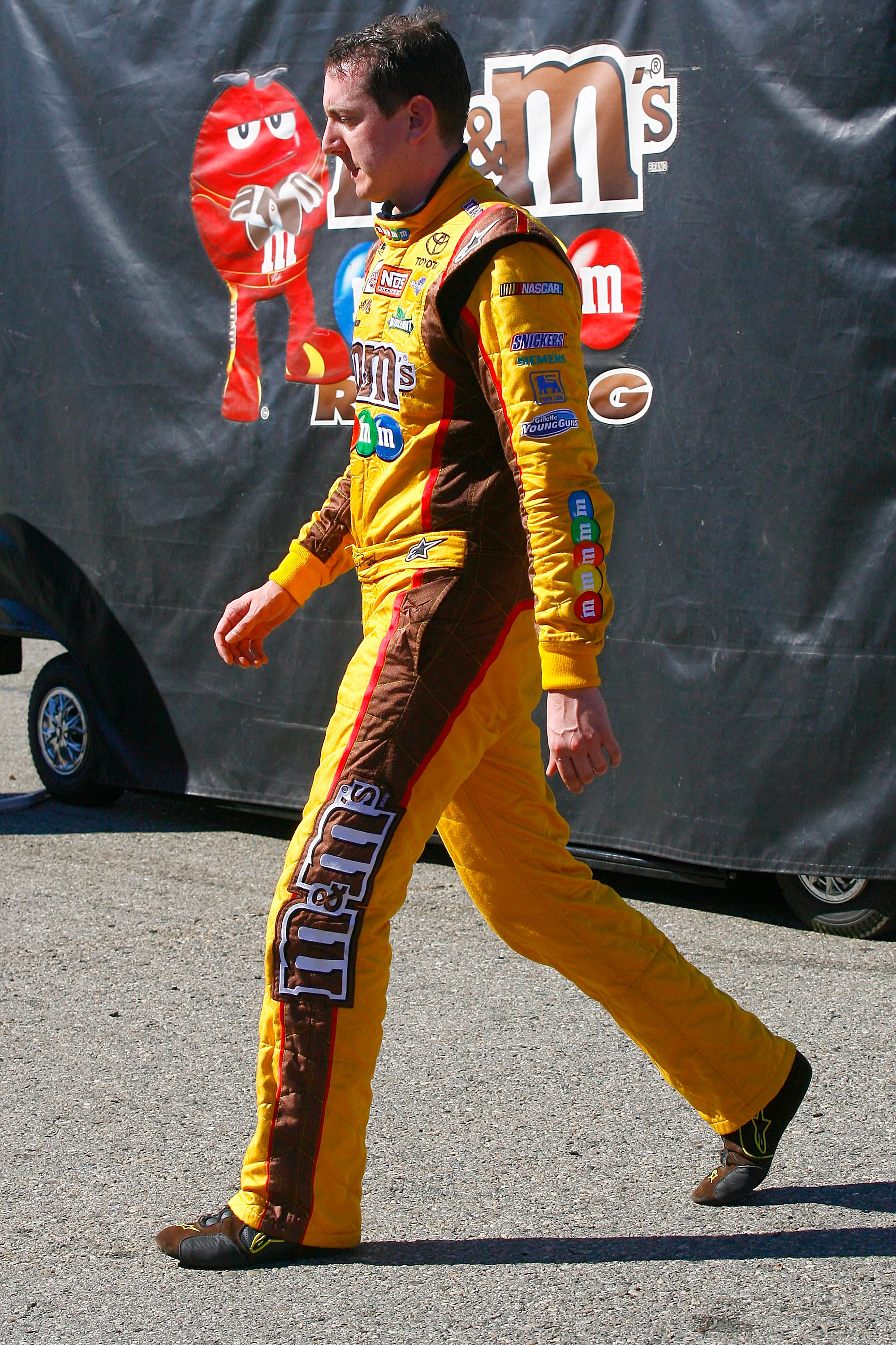FONTANA, CA - OCTOBER 10:  Kyle Busch, driver of the #18 M&M'sToyota, walks in the garage area after blowing a motor during the NASCAR Sprint Cup Series Pepsi Max 400 on October 10, 2010 in Fontana, California.  (Photo by Jason Smith/Getty Images for NASC