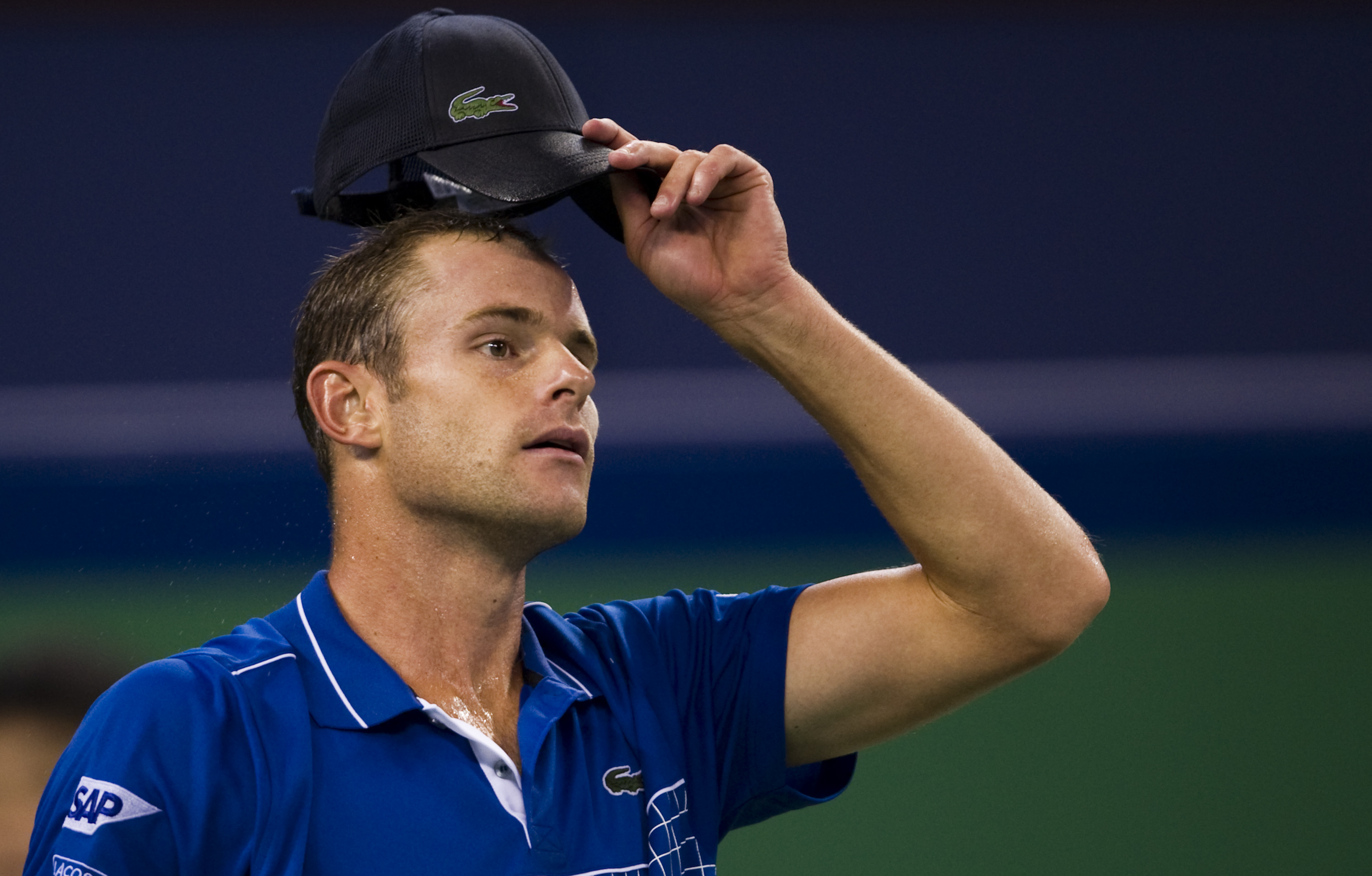 SHANGHAI, CHINA - OCTOBER 12: Andy Roddick of USA adjust his cap on his match against Philipp Kohlschreiber of Germany during day two of the 2010 Shanghai Rolex Masters at the Shanghai Qi Zhong Tennis Center on October 12, 2010 in Shanghai, China.  (Photo