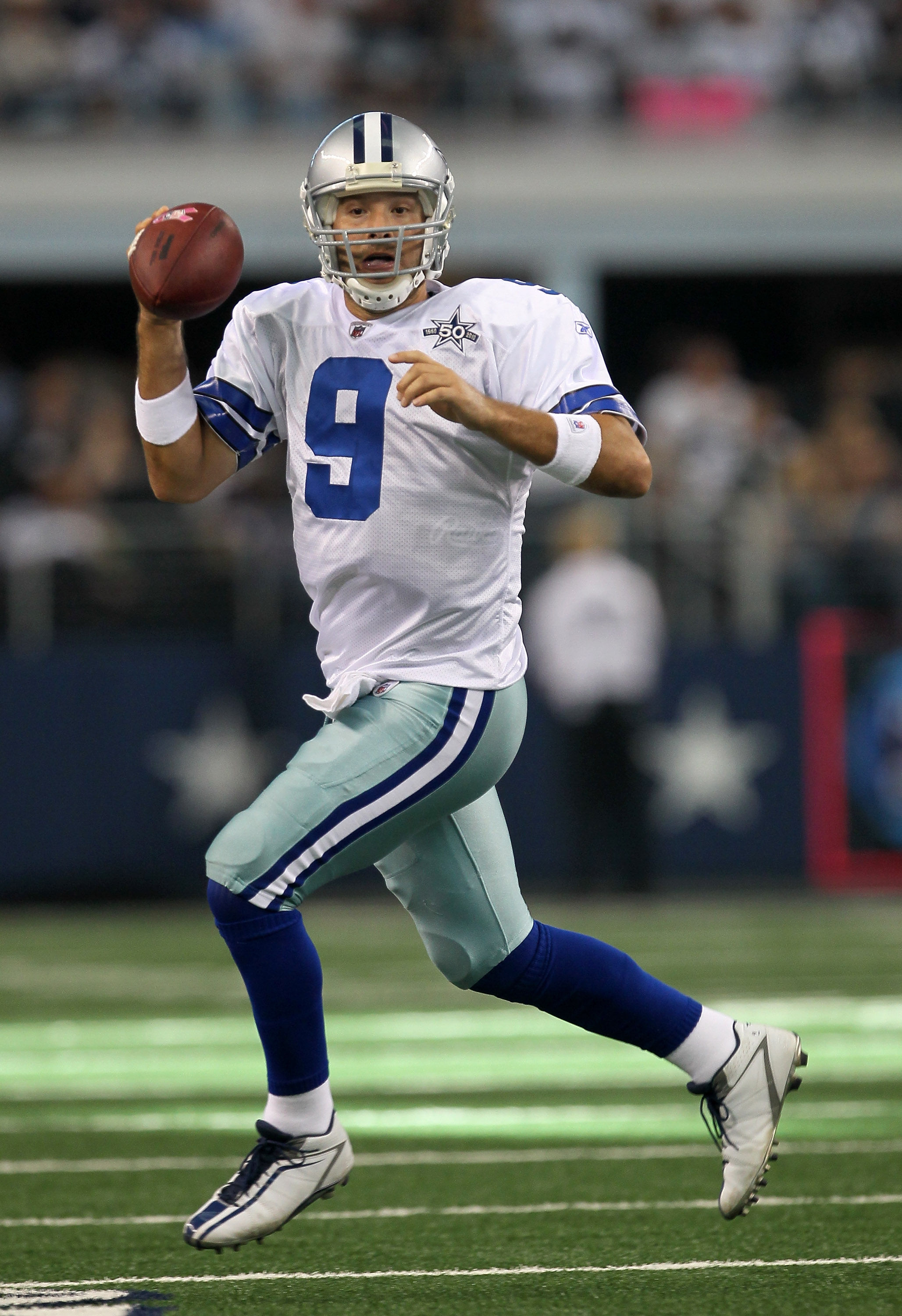 ARLINGTON, TX - OCTOBER 10:  Quarterback Tony Romo #9 of the Dallas Cowboys scrambles with the ball against the Tennessee Titans at Cowboys Stadium on October 10, 2010 in Arlington, Texas. The Titans won 34-27.  (Photo by Stephen Dunn/Getty Images)