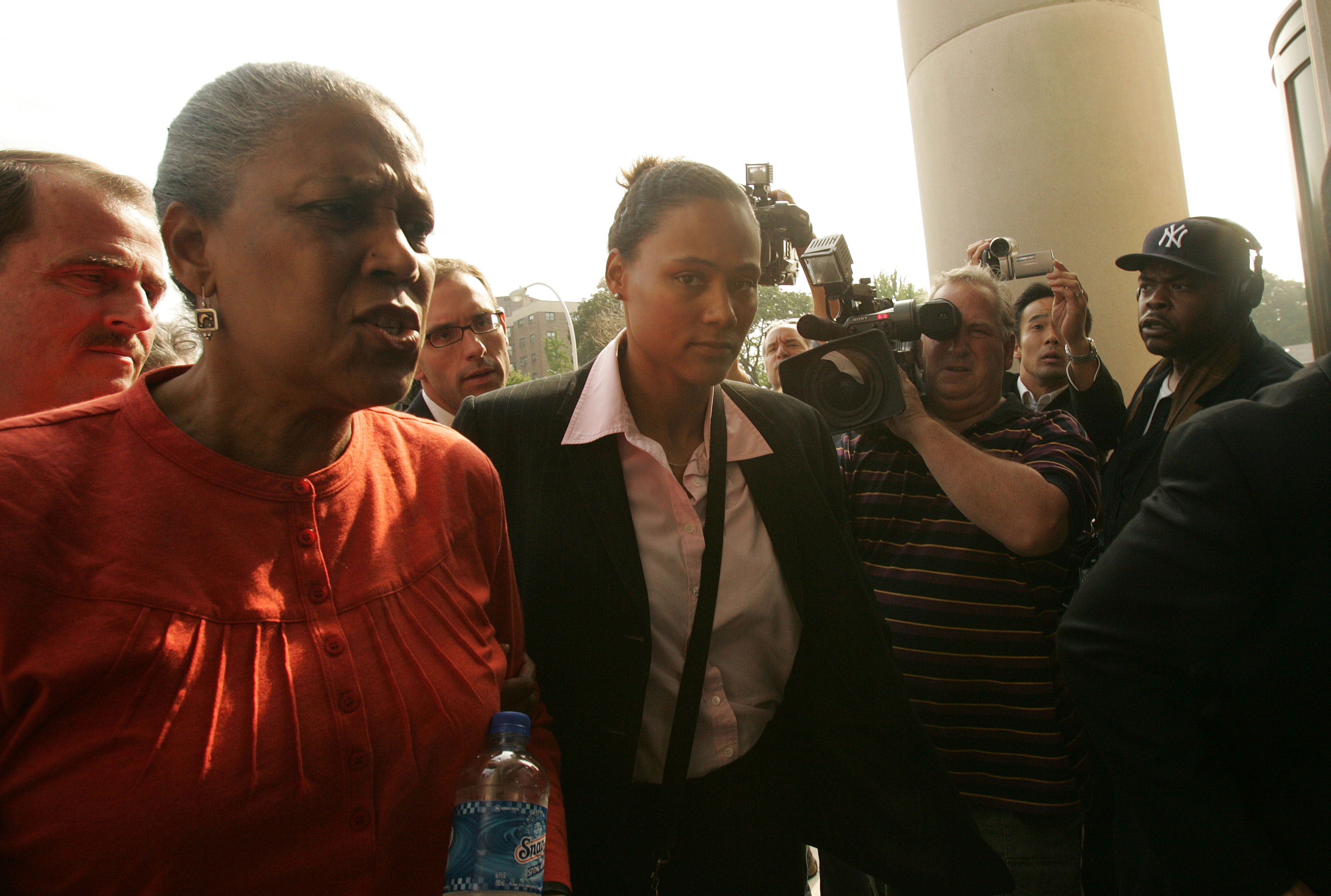 WHITE PLAINS, NY - OCTOBER 5:  Three-time Olympic gold medalist Marion Jones (C) enters a United States federal courthouse October 5, 2007 in White Plains, New York. Jones is expected to plead guilty to charges in connection with steroid use.  (Photo by H