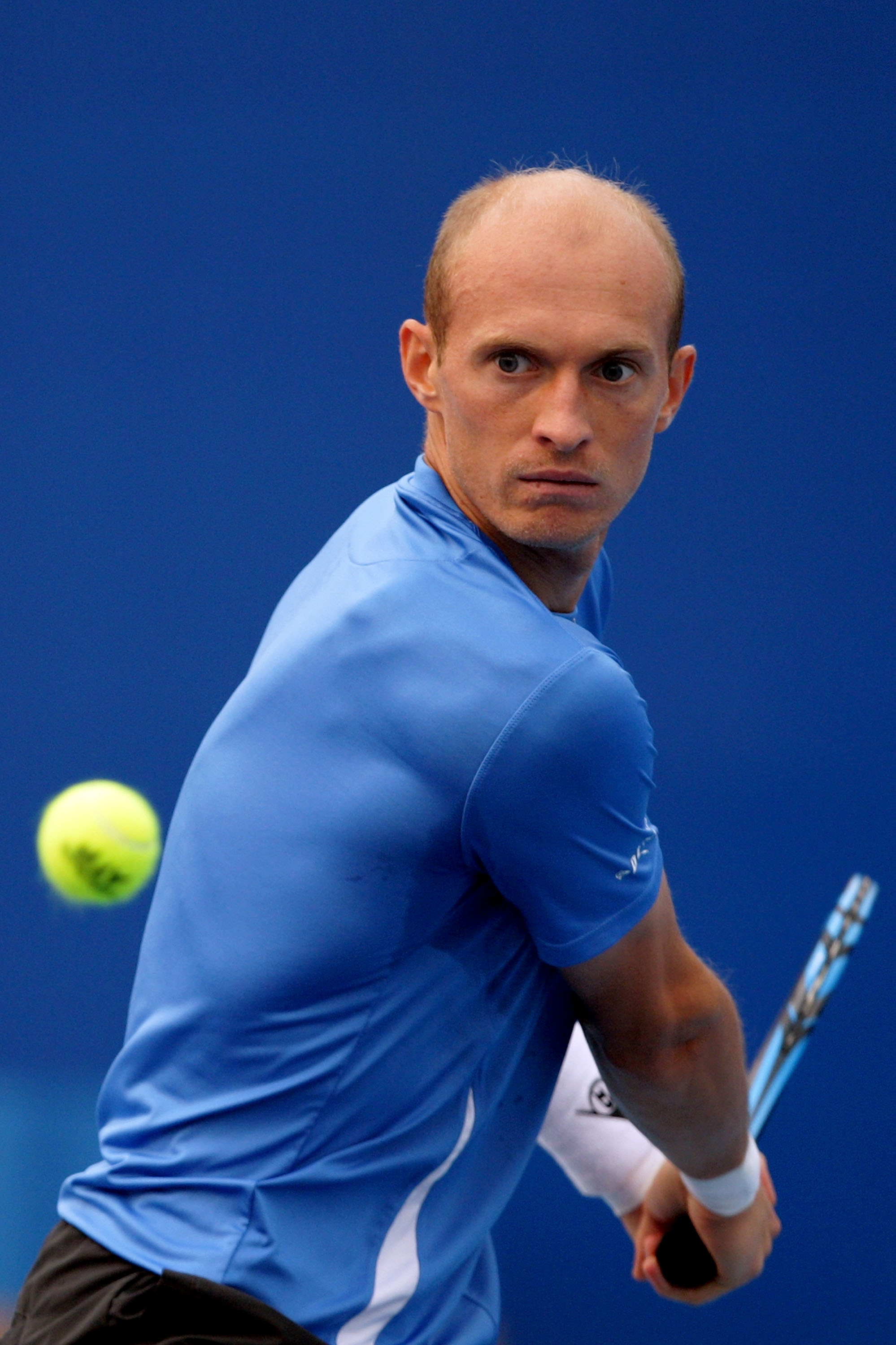 BEIJING - OCTOBER 08:  Nikolay Davydenko of Russia plays a backhand during his match against John Isner of United States  during day eight of the 2010 China Open at the National Tennis Center on October 8, 2010 in Beijing, China.  (Photo by Lintao Zhang/G