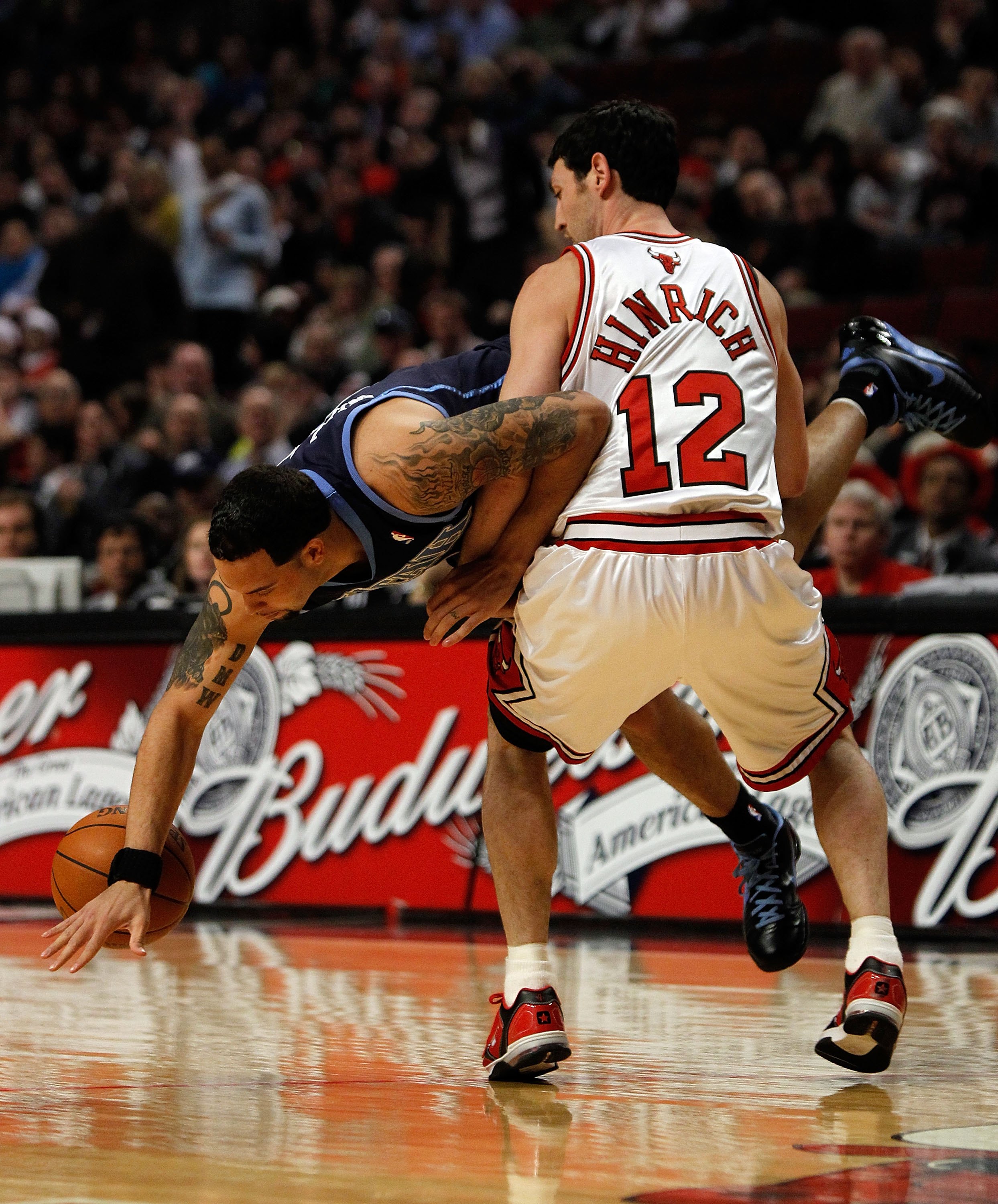 CHICAGO - MARCH 09: Deron Williams #8 of the Utah Jazz flips in the air and looses the ball as he is fouled by Kirk Hinrich #12 of the Chicago Bulls at the United Center on March 9, 2010 in Chicago, Illinois. The Jazz defeated the Bulls 132-108. NOTE TO U