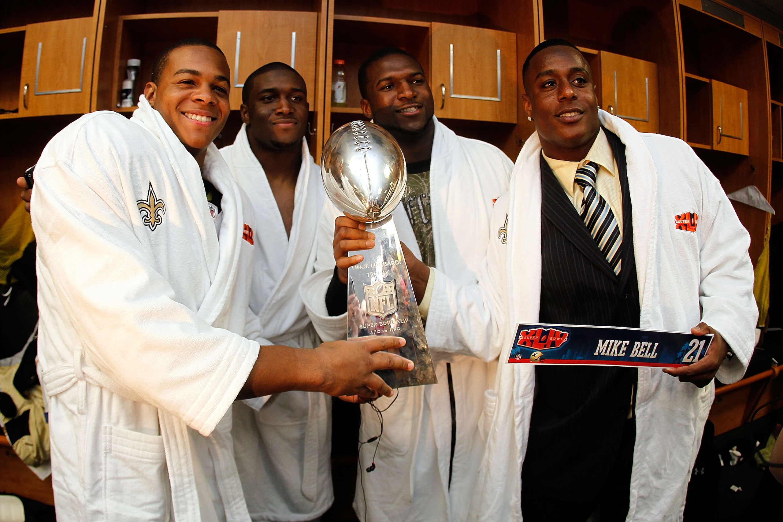 MIAMI GARDENS, FL - FEBRUARY 07: (L-R) Pierre Thomas #23, Reggie Bush #25, Lynell Hamilton #30 and Mike Bell #21 of the New Orleans Saints celebrate in the locker room with the Vince Lombardi Trophy after defeating the Indianapolis Colts during Super Bow MIAMI GARDENS, FL - FEBRUARY 07: (L-R) Pierre Thomas #23, Reggie Bush #25, Lynell Hamilton #30 and Mike Bell #21 of the New Orleans Saints celebrate in the locker room with the Vince Lombardi Trophy after defeating the Indianapolis Colts during Super Bow